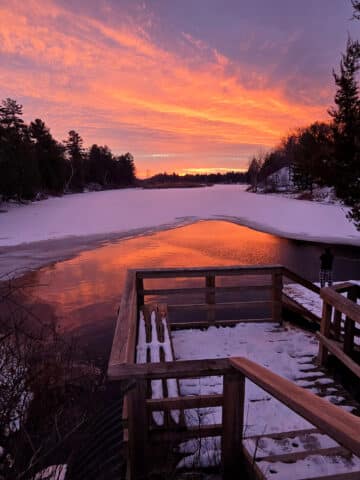 A bright pink sunset over old ausable channel in winter, at pinery provincial park.