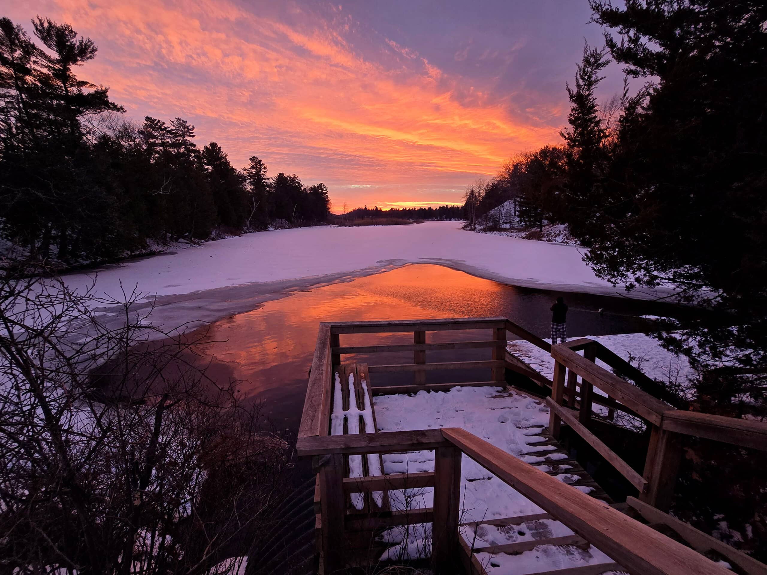 A bright pink sunset over old ausable channel in winter, at pinery provincial park.