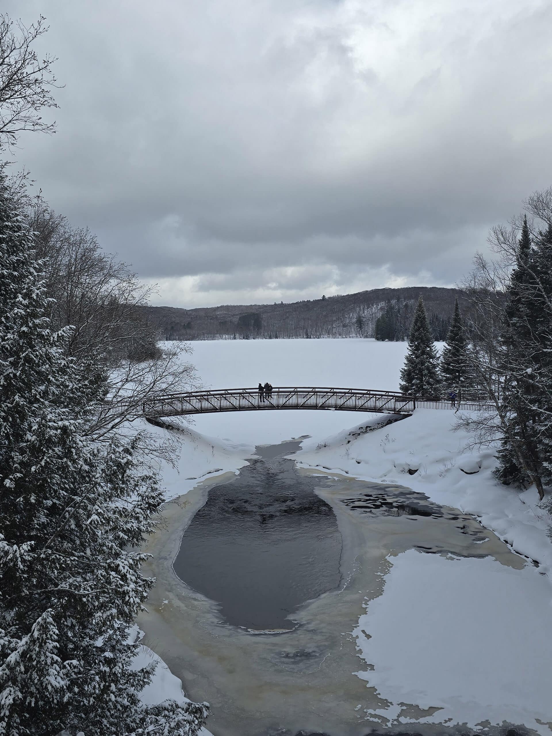 A winter view over arrowhead lake and a bridge.