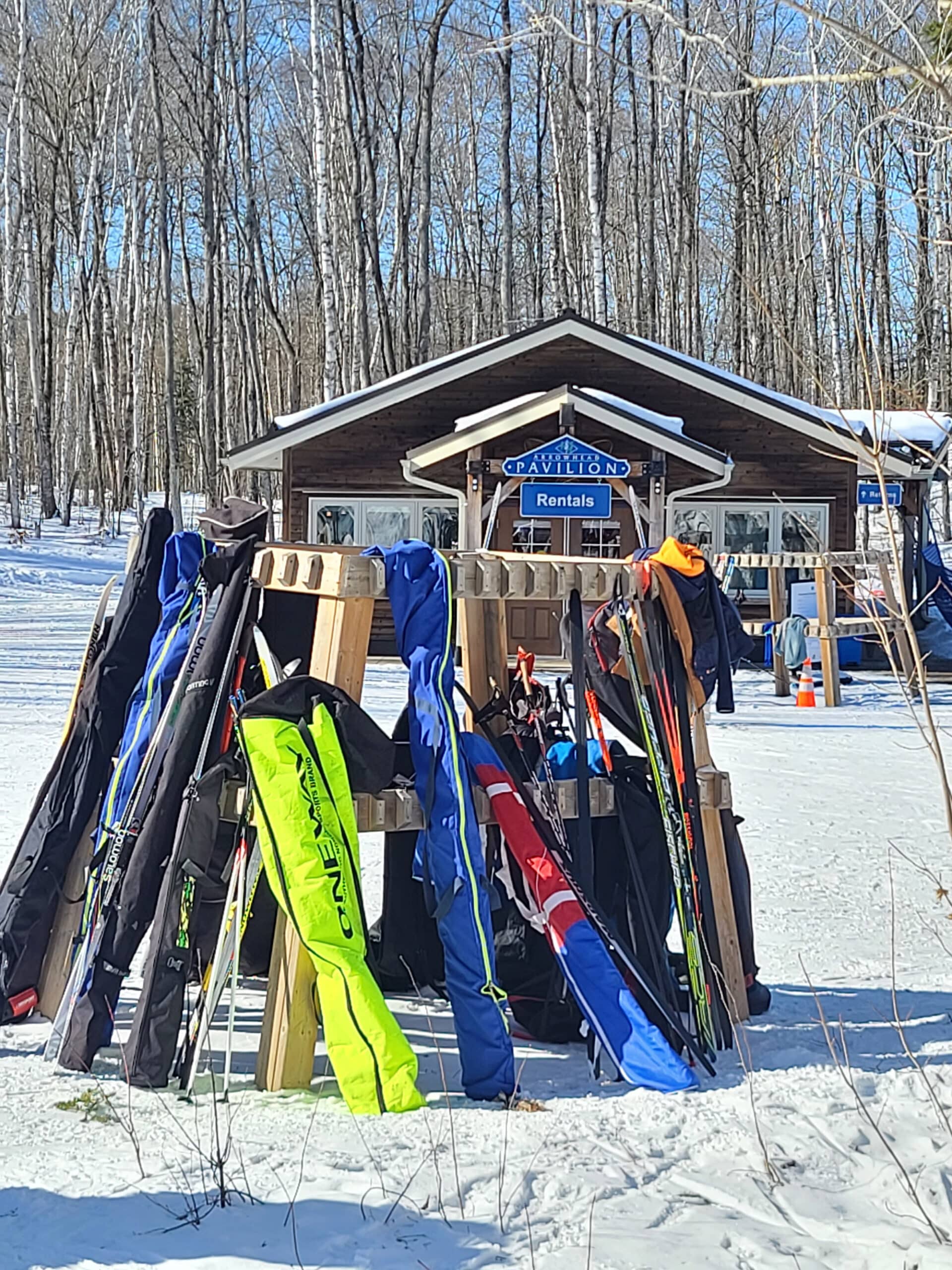 A rack full of skis outside at arrowhead provincial park in the winter.