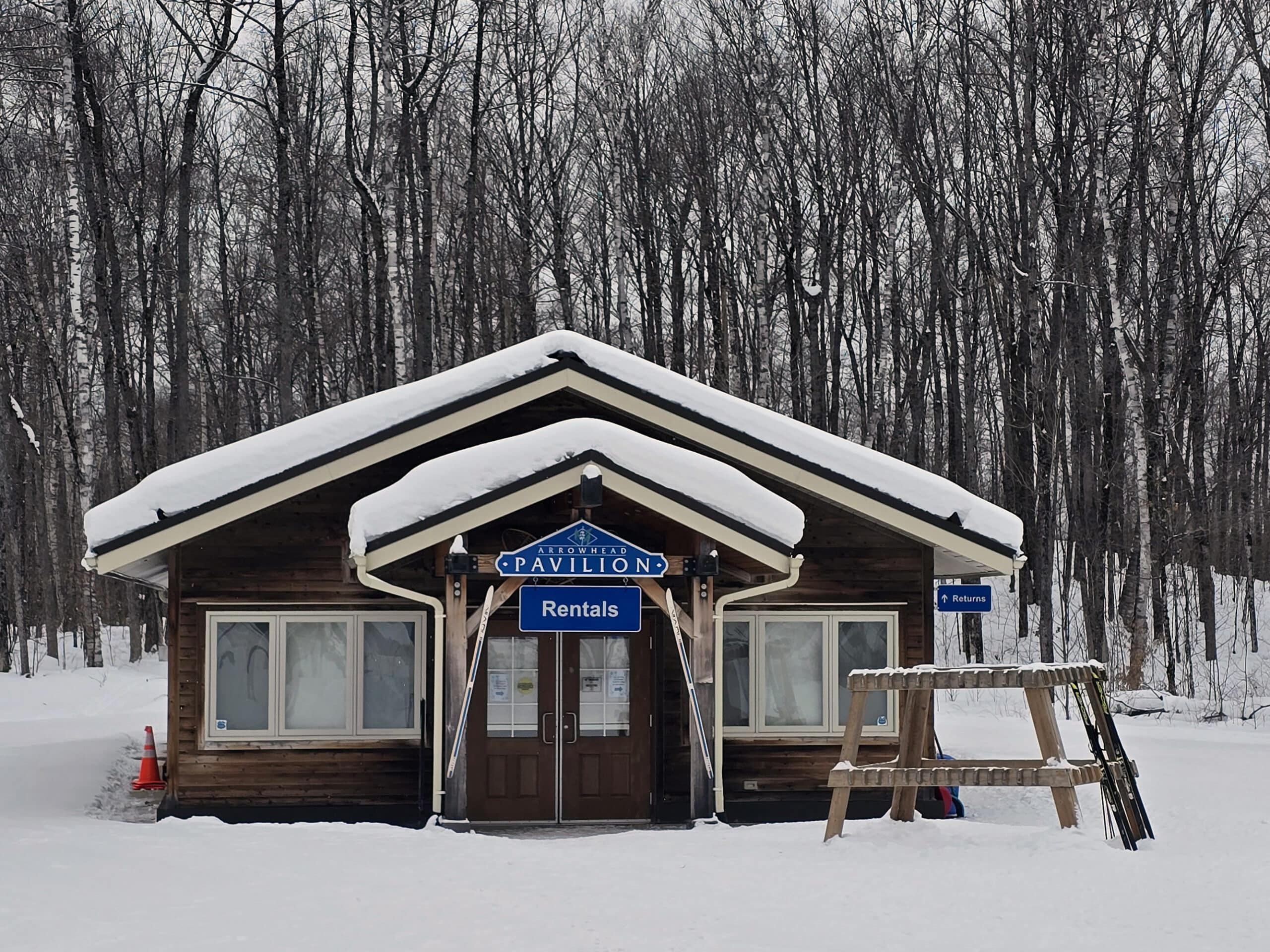 A snow covered building labeled as arrowhead provincial park rentals.