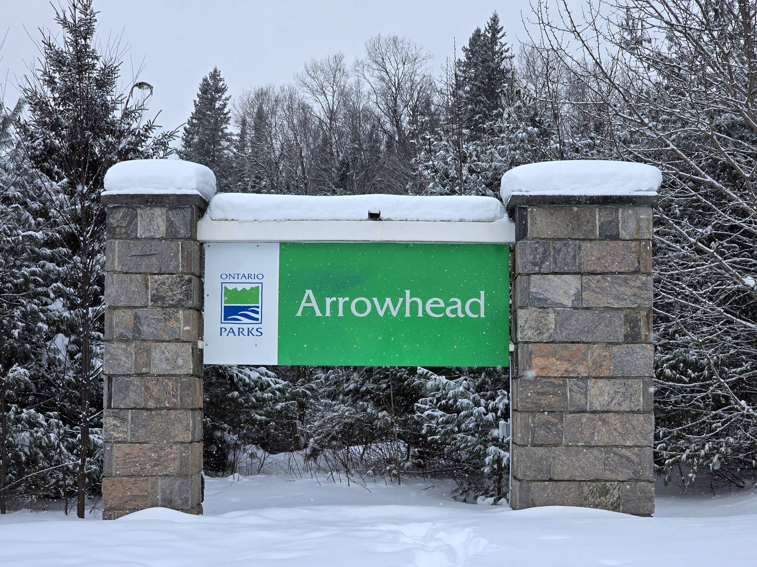 The arrowhead provincial park sign in winter.