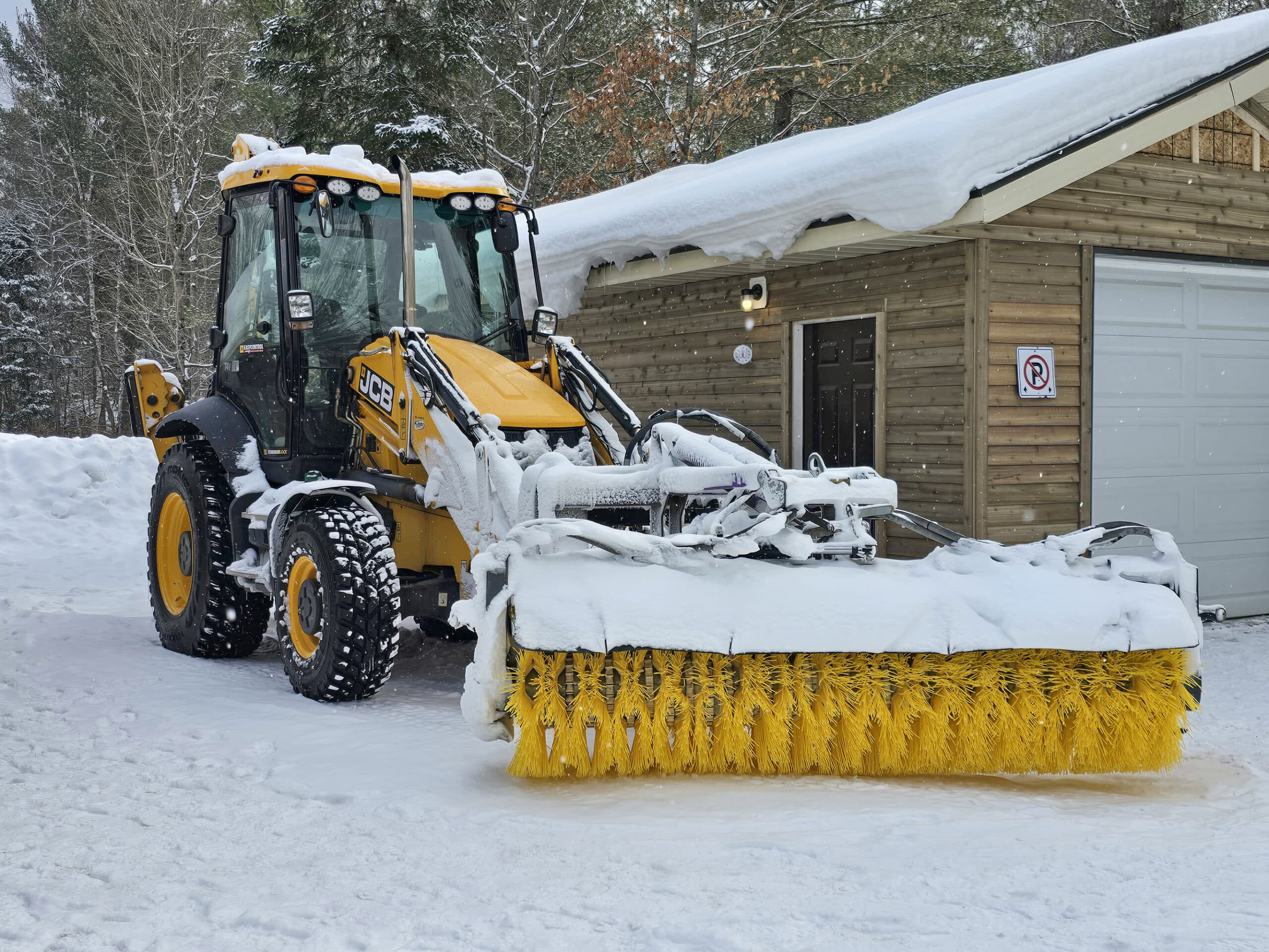 A large tractor with snow clearing attachment.