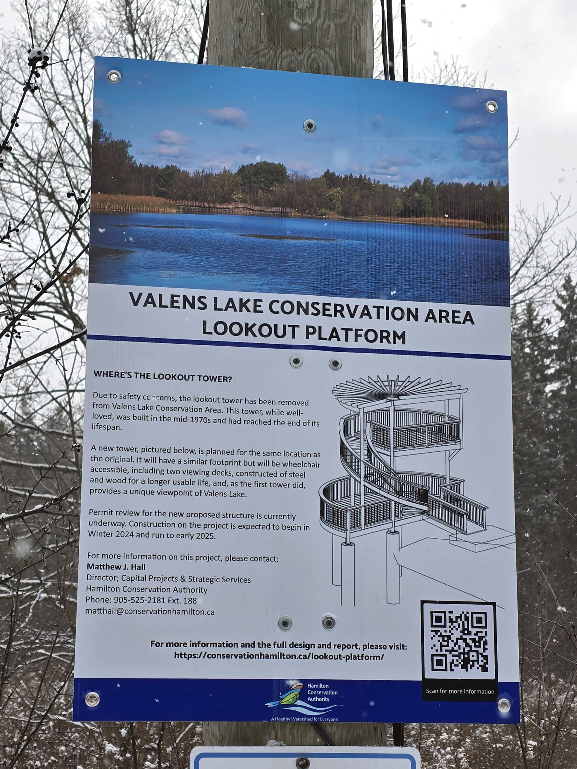 A trail sign with information and a schematic design of the new lookout platform they're building.