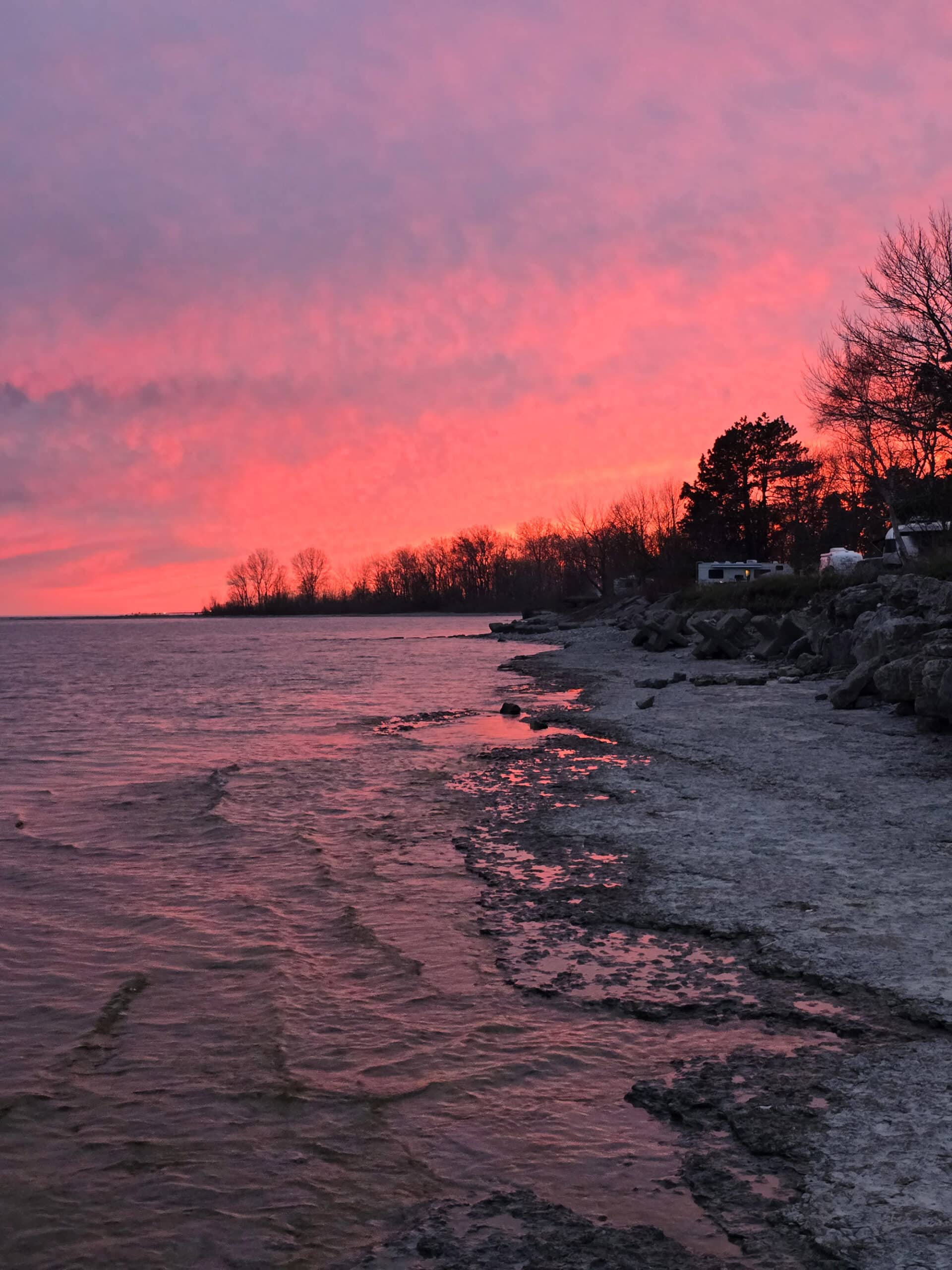 A bright pink sunset over lake ontario at Presqu’ile Provincial Park.