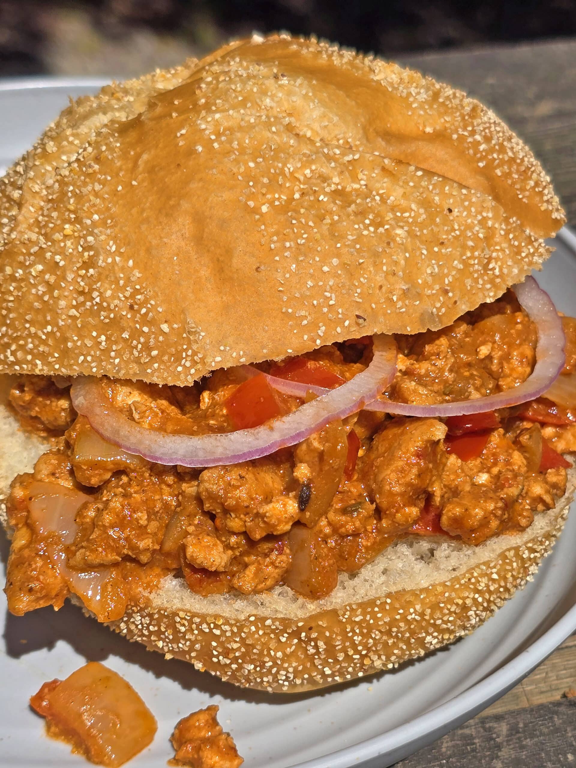 A Bombay Joes sloppy joe sandwich on a plate.