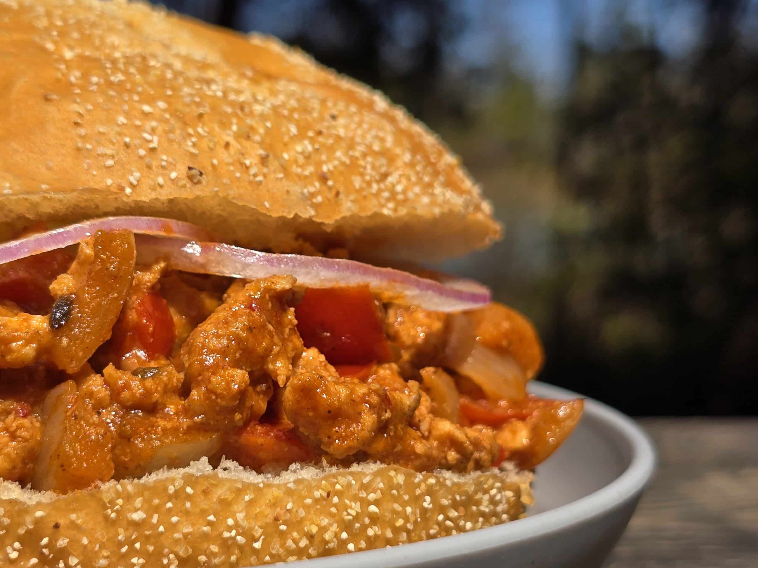 A Bombay Joes sloppy joe sandwich on a plate.