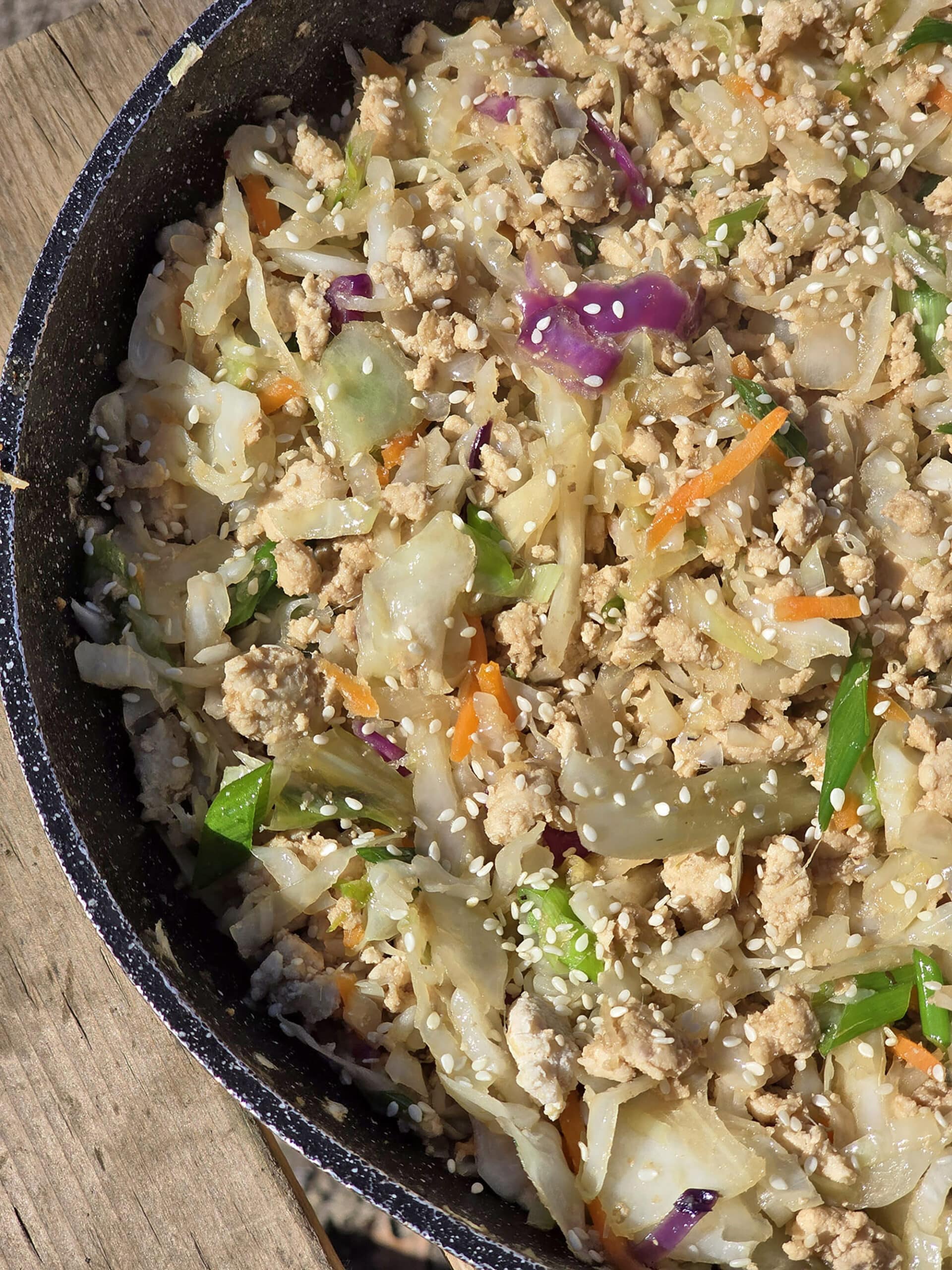A pan of egg roll in a pan -shredded cabbage, ground beef, and more.