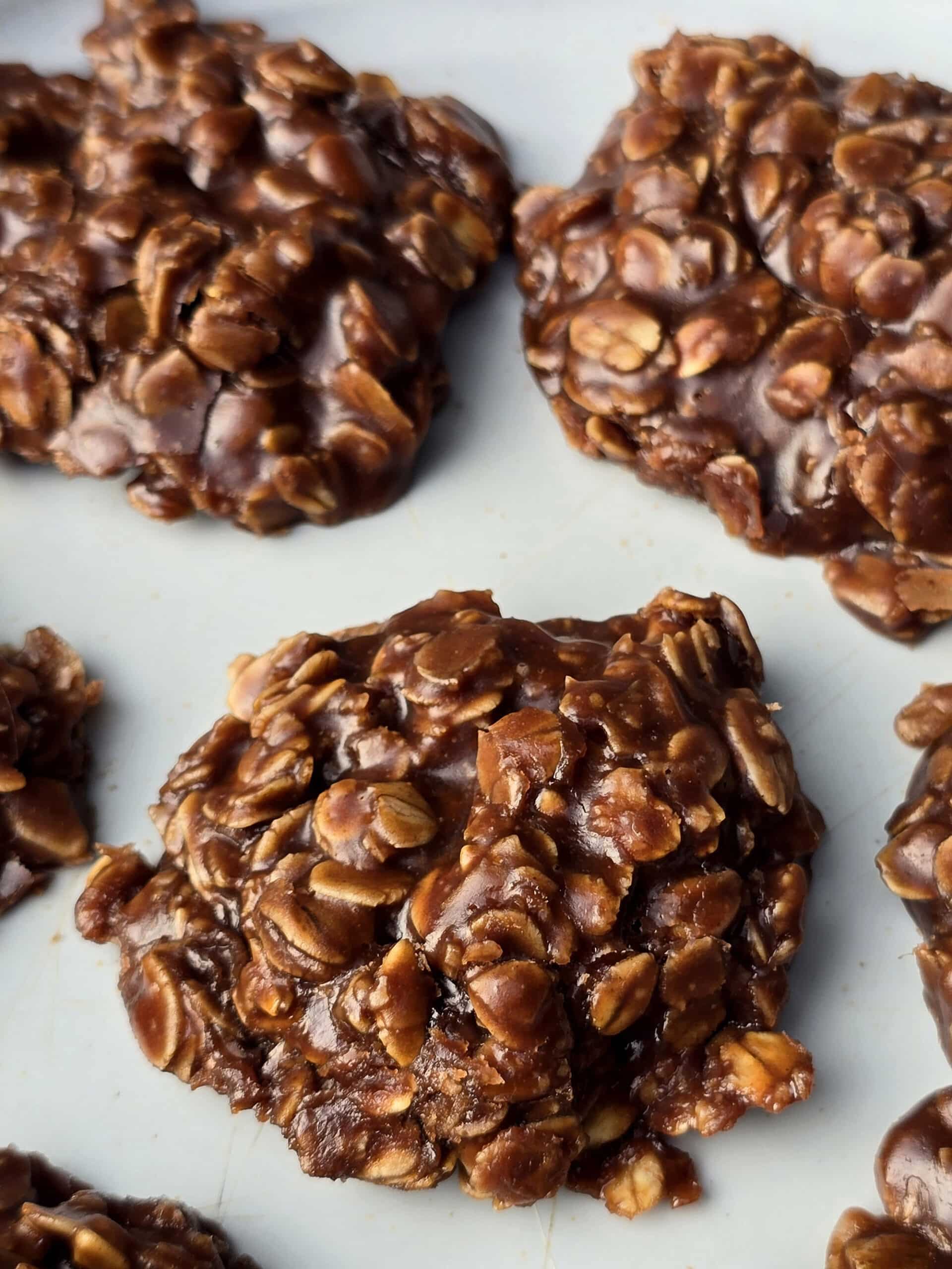 A plate of chocolate peanut butter no bake cookies with oats.