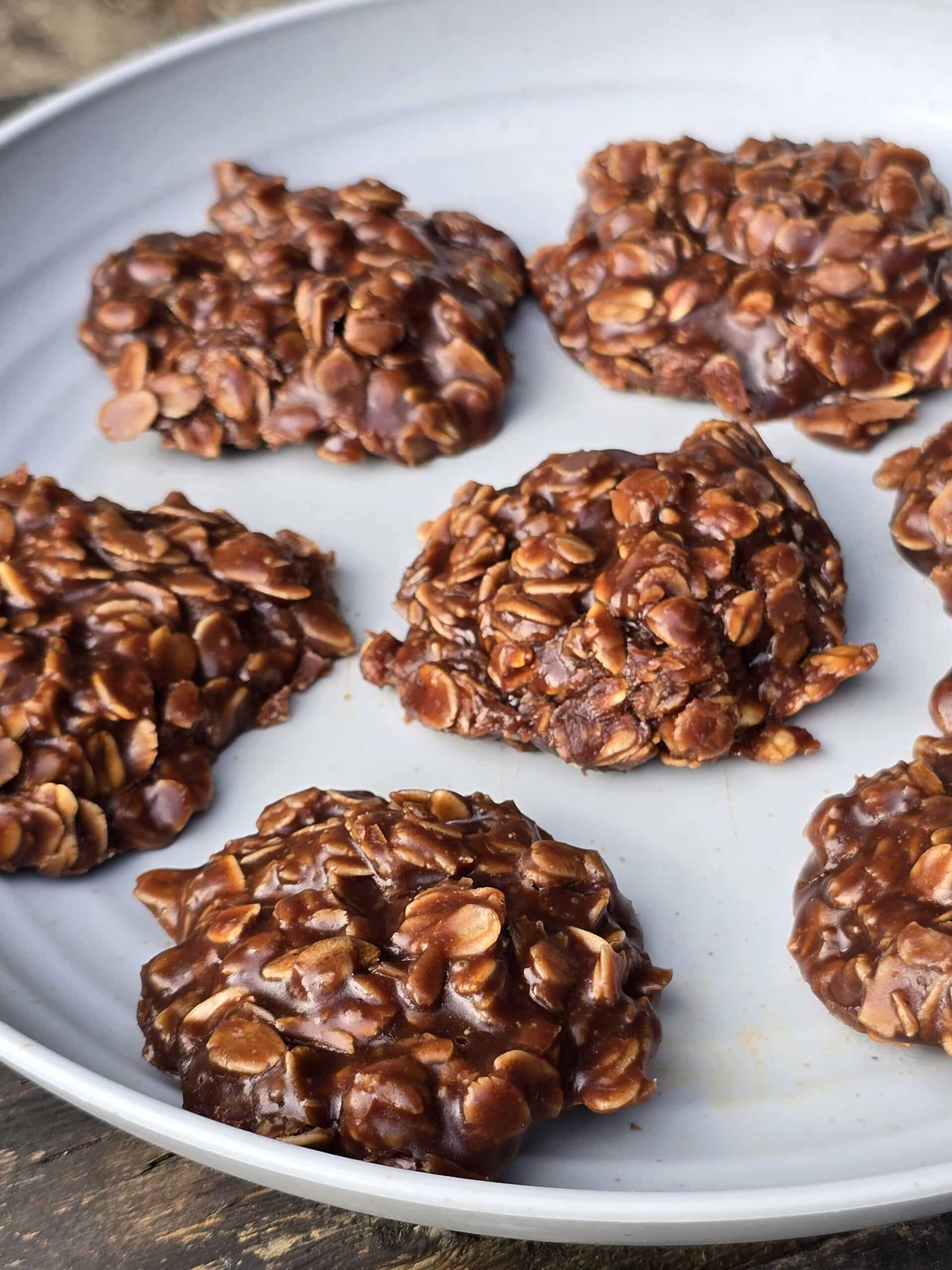 A plate of chocolate peanut butter no bake cookies with oats.