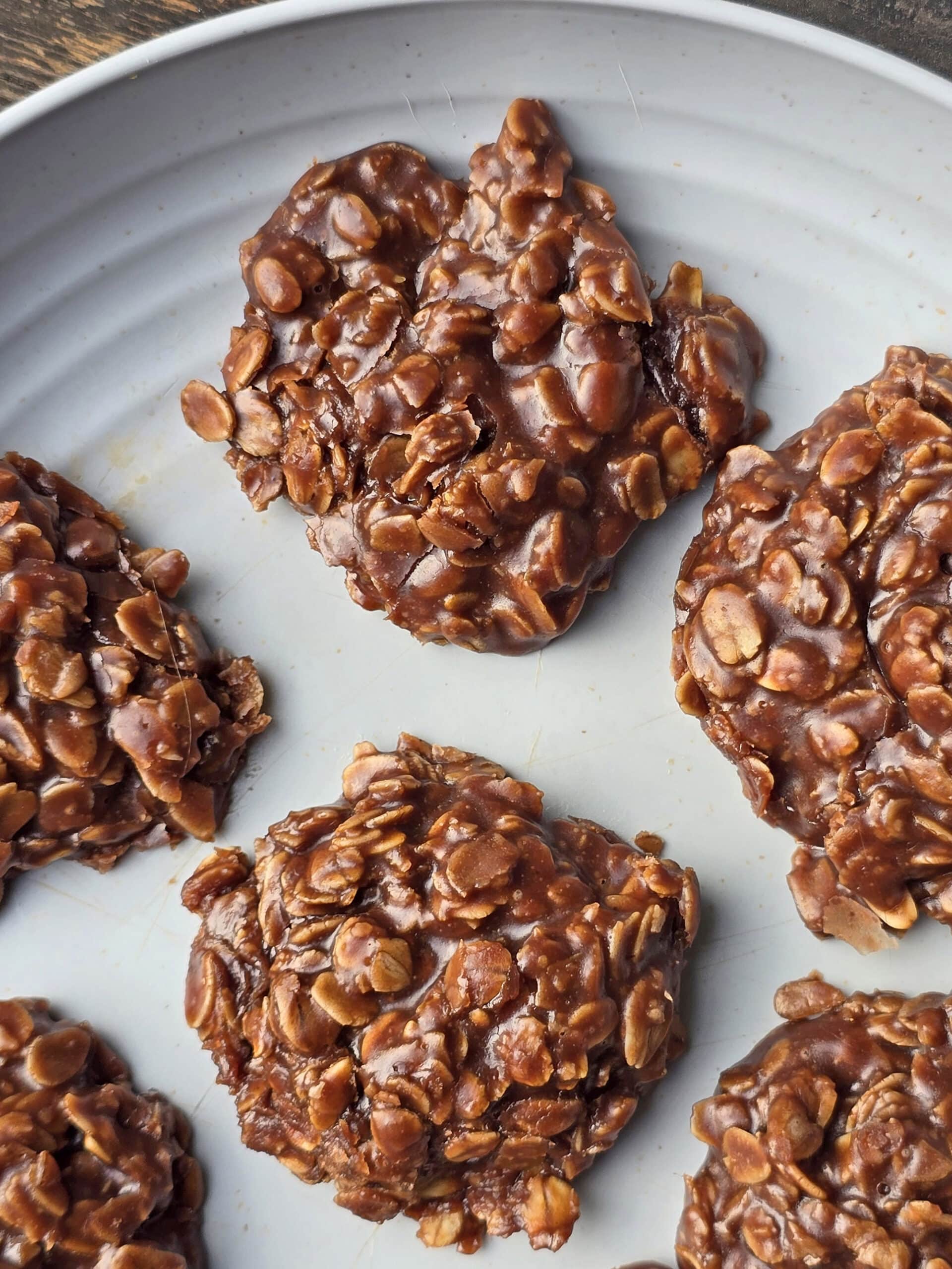 A plate of chocolate peanut butter no bake cookies with oats.