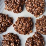 A plate of chocolate peanut butter no bake cookies with oats.
