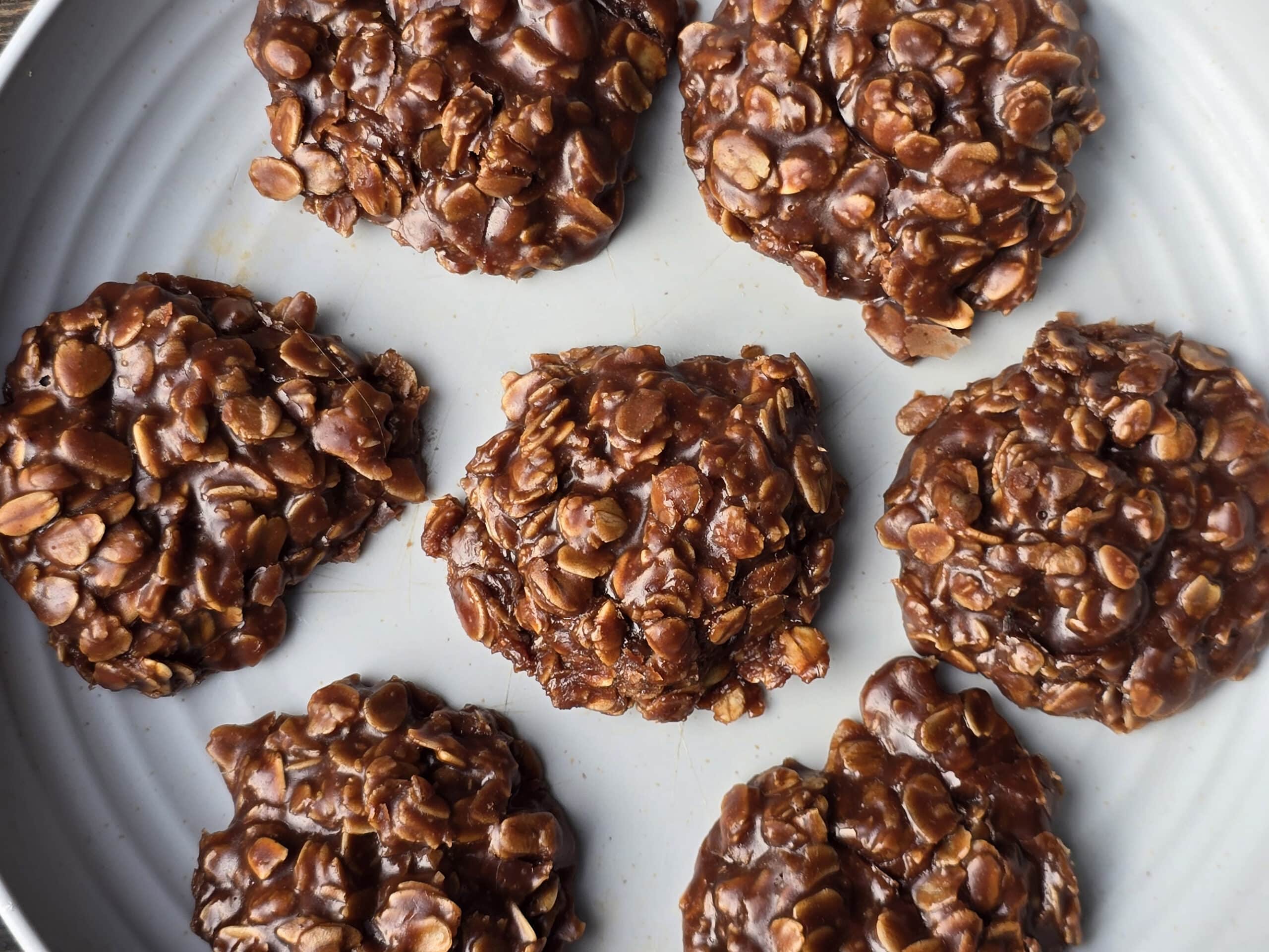 A plate of chocolate peanut butter no bake cookies with oats.
