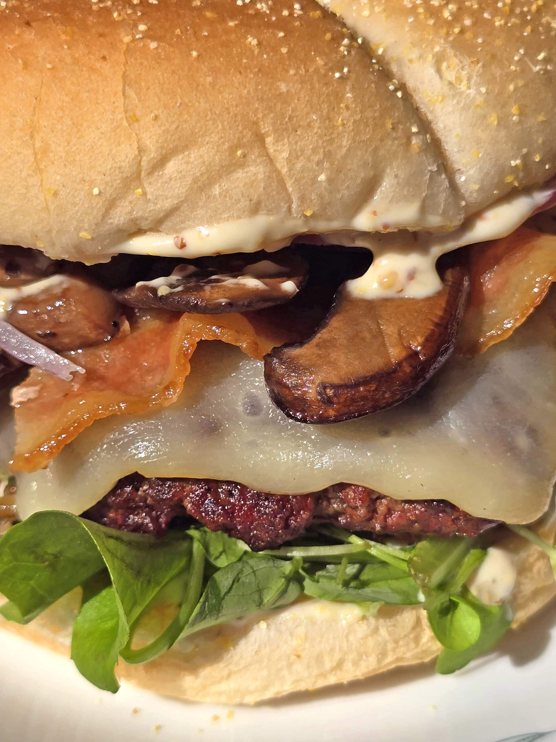 A juicy elk burger with bacon, smoked cheddar, sauteed mushrooms, and dijonnaise.