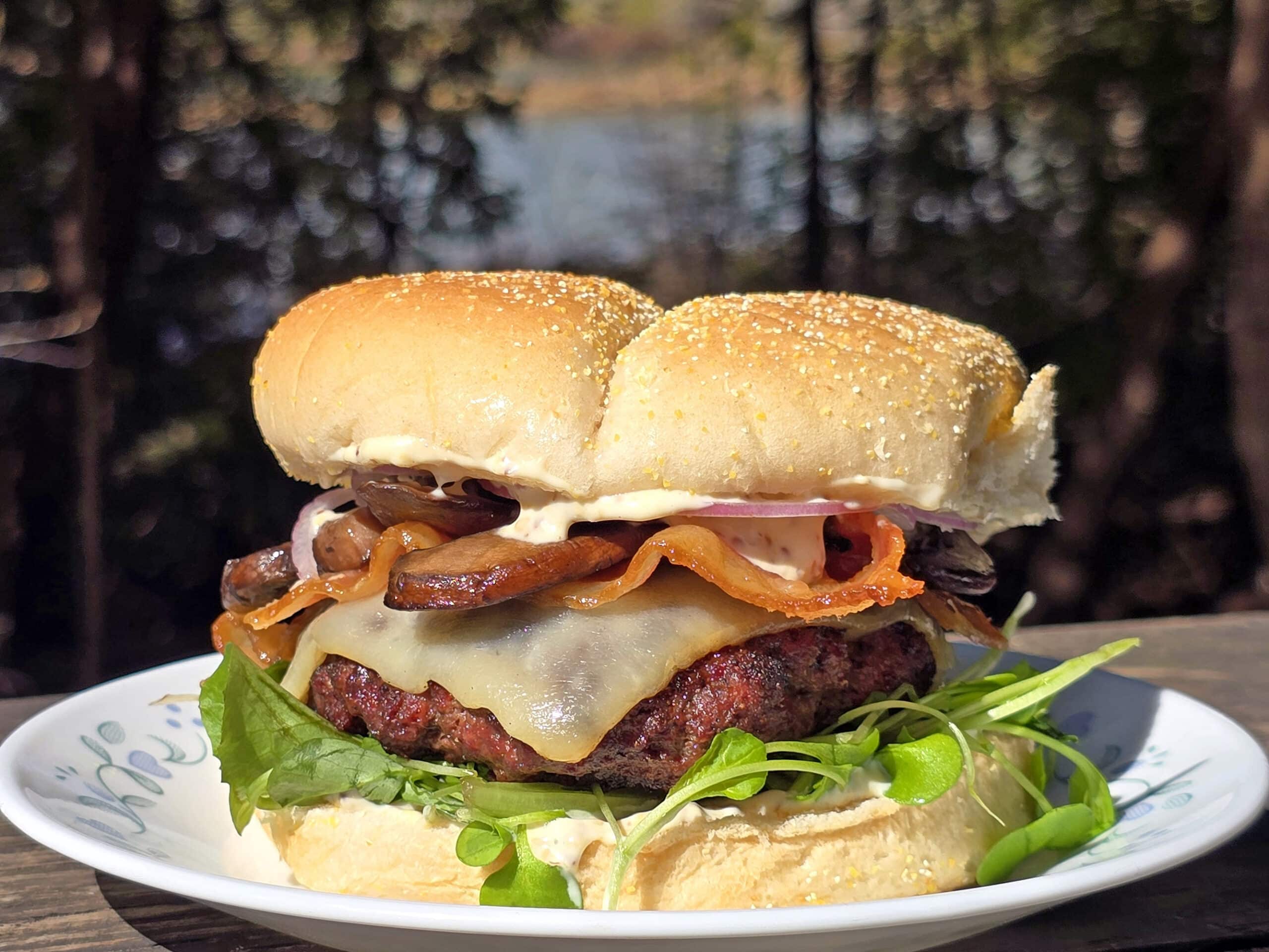 A juicy elk burger with bacon, smoked cheddar, sauteed mushrooms, and dijonnaise.
