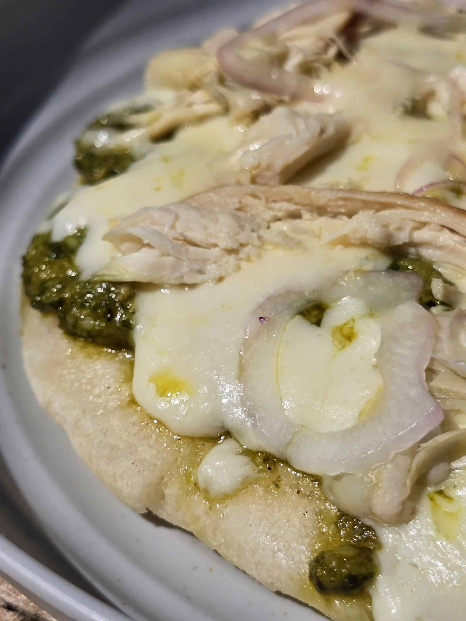 An individual campfire pizza on a plate.