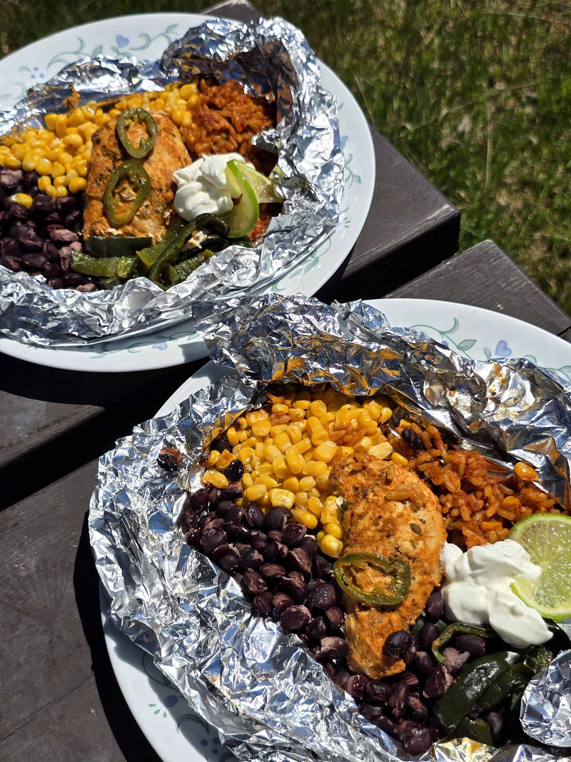 A Southwestern Chicken foil packet, with Southwest marinated chicken, black beans, corn, Mexican rice, and poblano peppers.