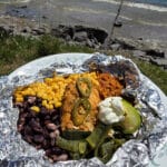 A Southwest Chicken foil packet, with Southwest marinated chicken, black beans, corn, Mexican rice, and poblano peppers.