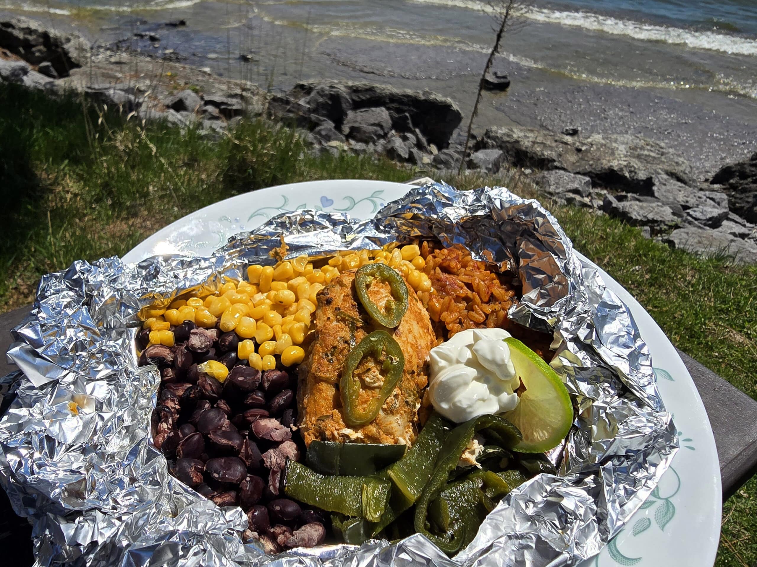 A Southwest Chicken foil packet, with Southwest marinated chicken, black beans, corn, Mexican rice, and poblano peppers.