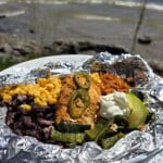 A Southwestern Chicken foil packet, with Southwest marinated chicken, black beans, corn, Mexican rice, and poblano peppers.