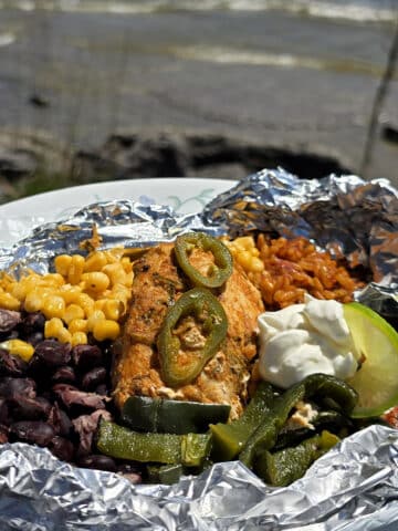 A Southwestern Chicken foil packet, with Southwest marinated chicken, black beans, corn, Mexican rice, and poblano peppers.
