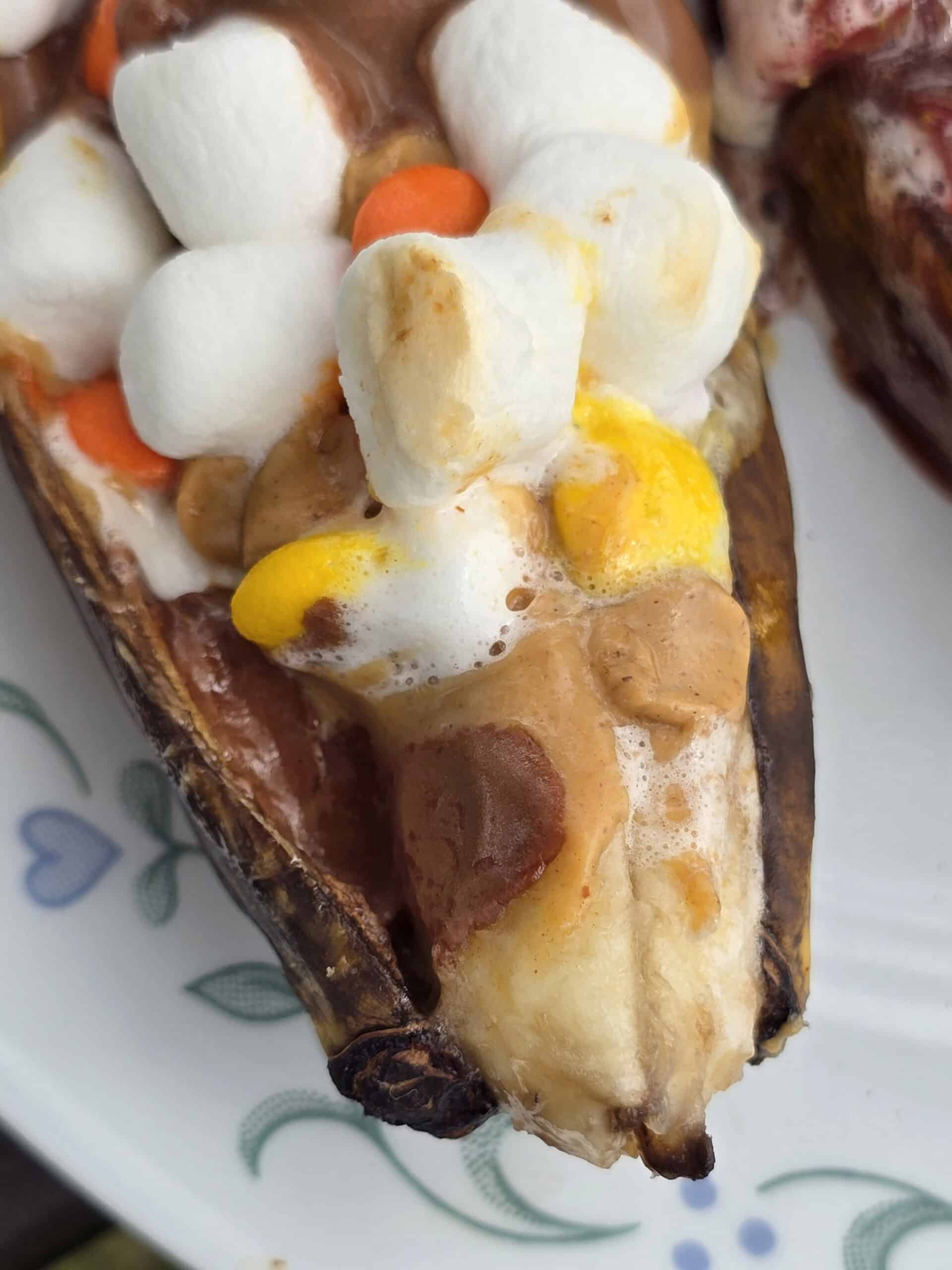 1 grilled banana boats stuffed with reeses pieces peanut butter cups and marshmallows.