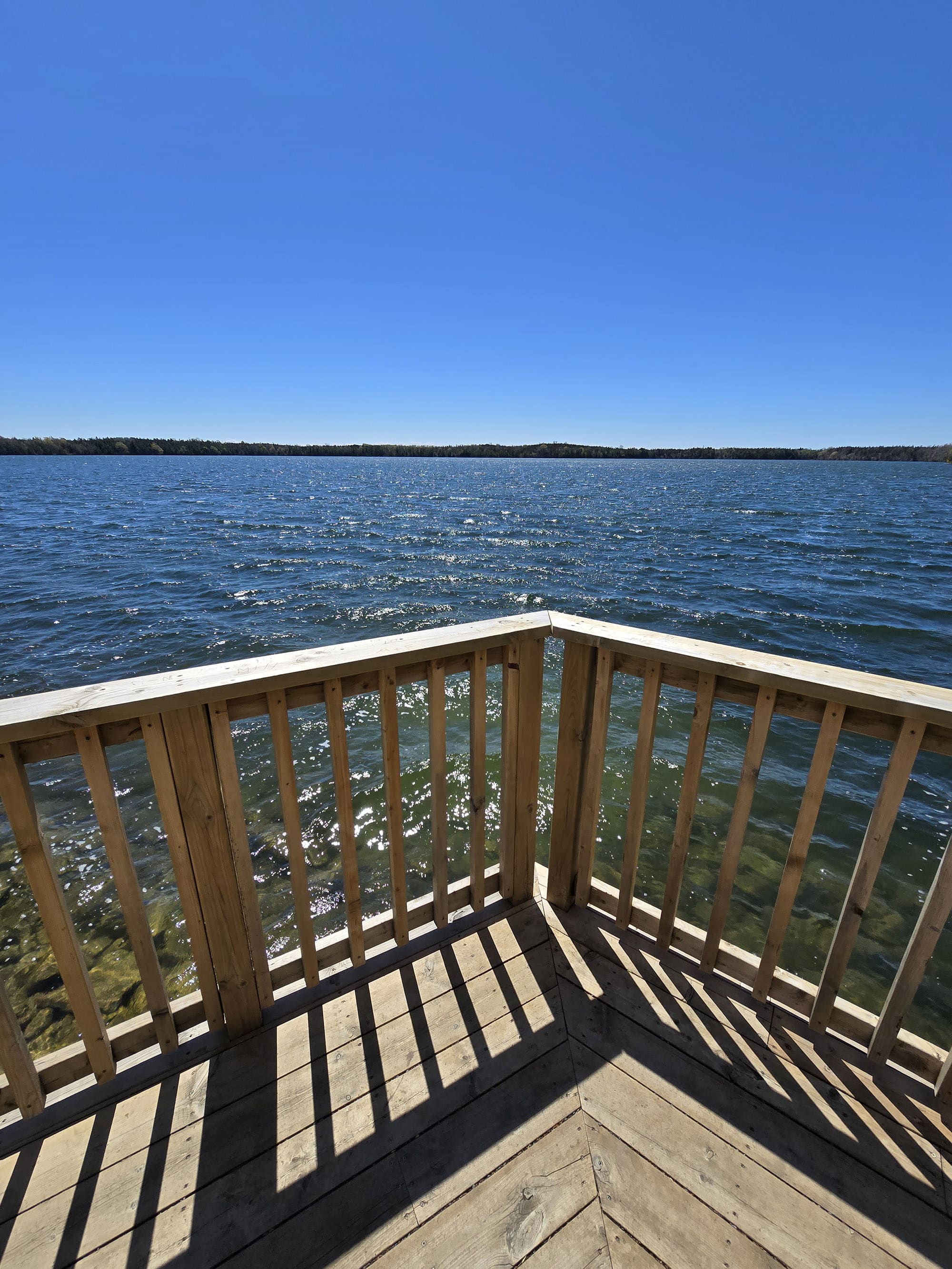 A wooden viewing platform deck on the side of Lake on the Mountain Provincial Park.