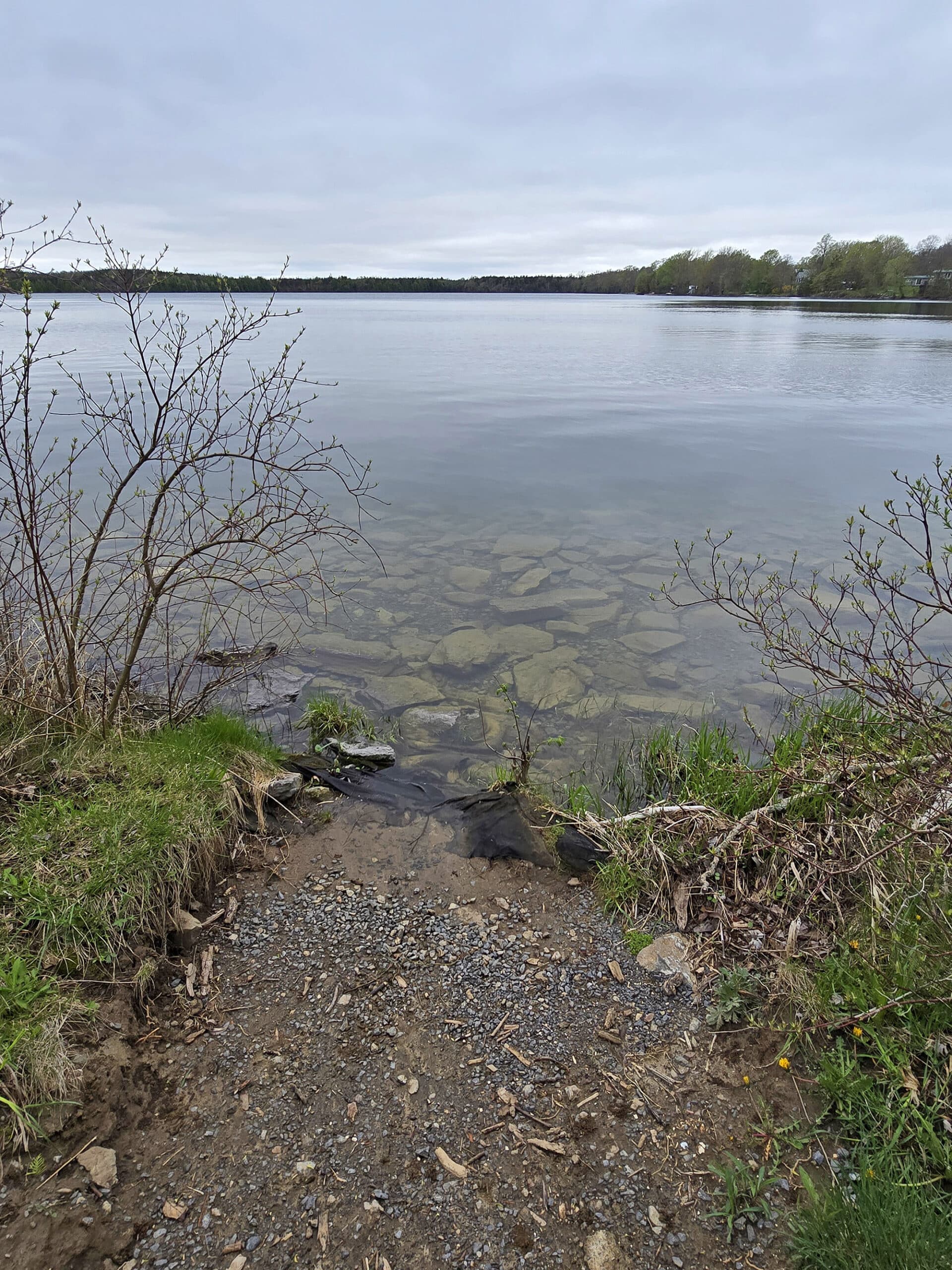 A large natural lake as viewed from the shoreline.