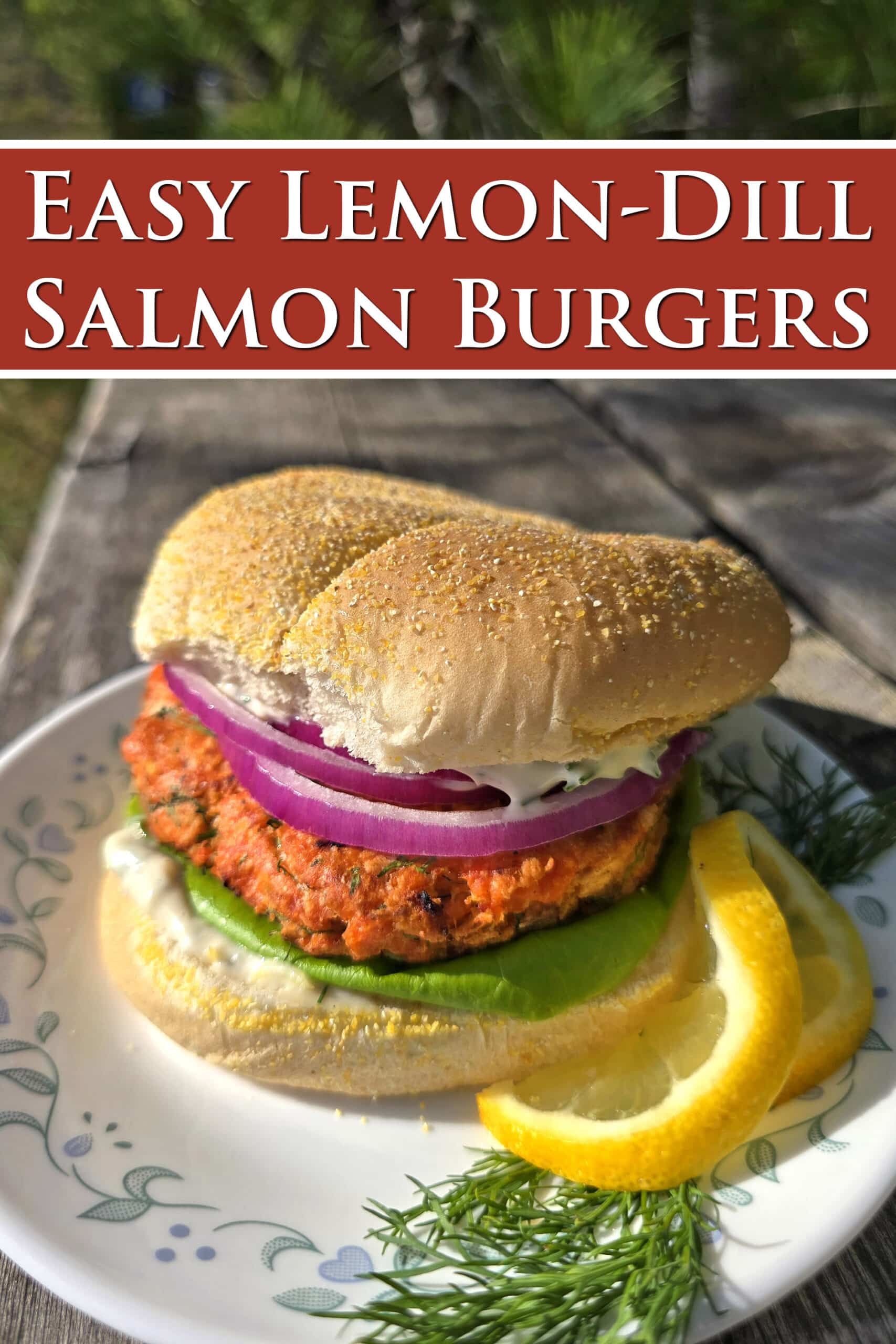 A Lemon dill salmon burger with lettuce, lemon dill mayonnaise, and red onions. Overlaid text says easy lemon-dill salmon burgers.