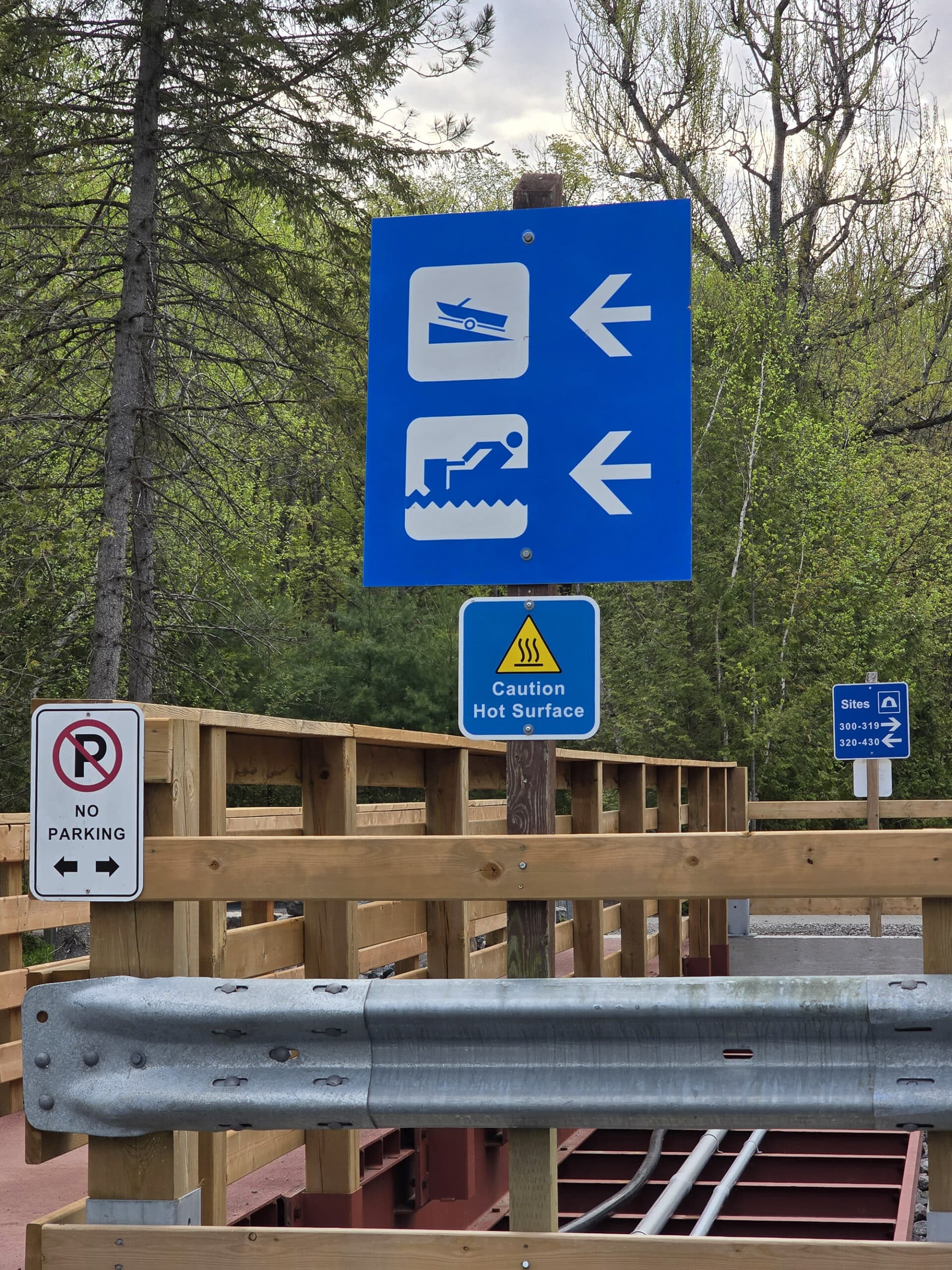 Several directional signs on a small bridge.