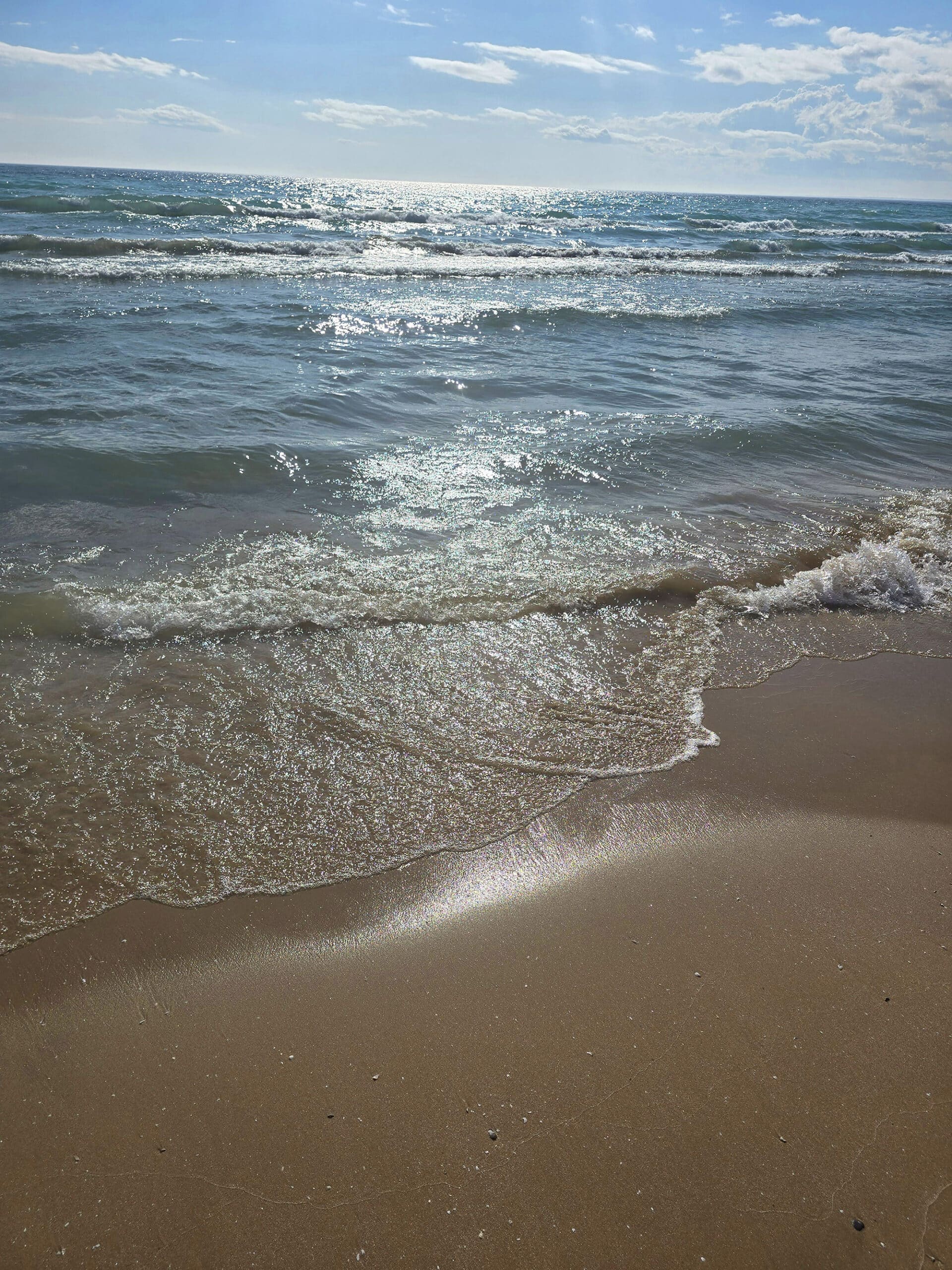 A sandy beach on a sunny day at Sandbanks provincial park.