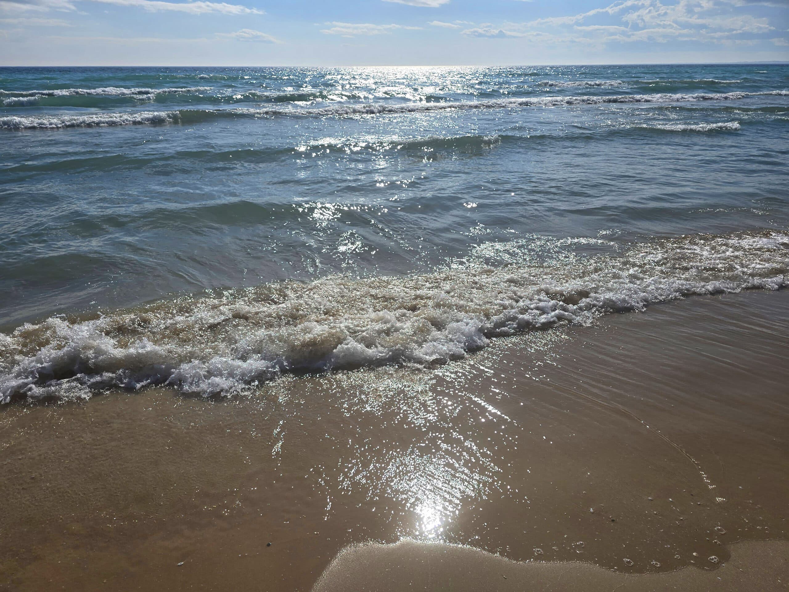 A sandy beach on a sunny day, at sandbanks provincial park.