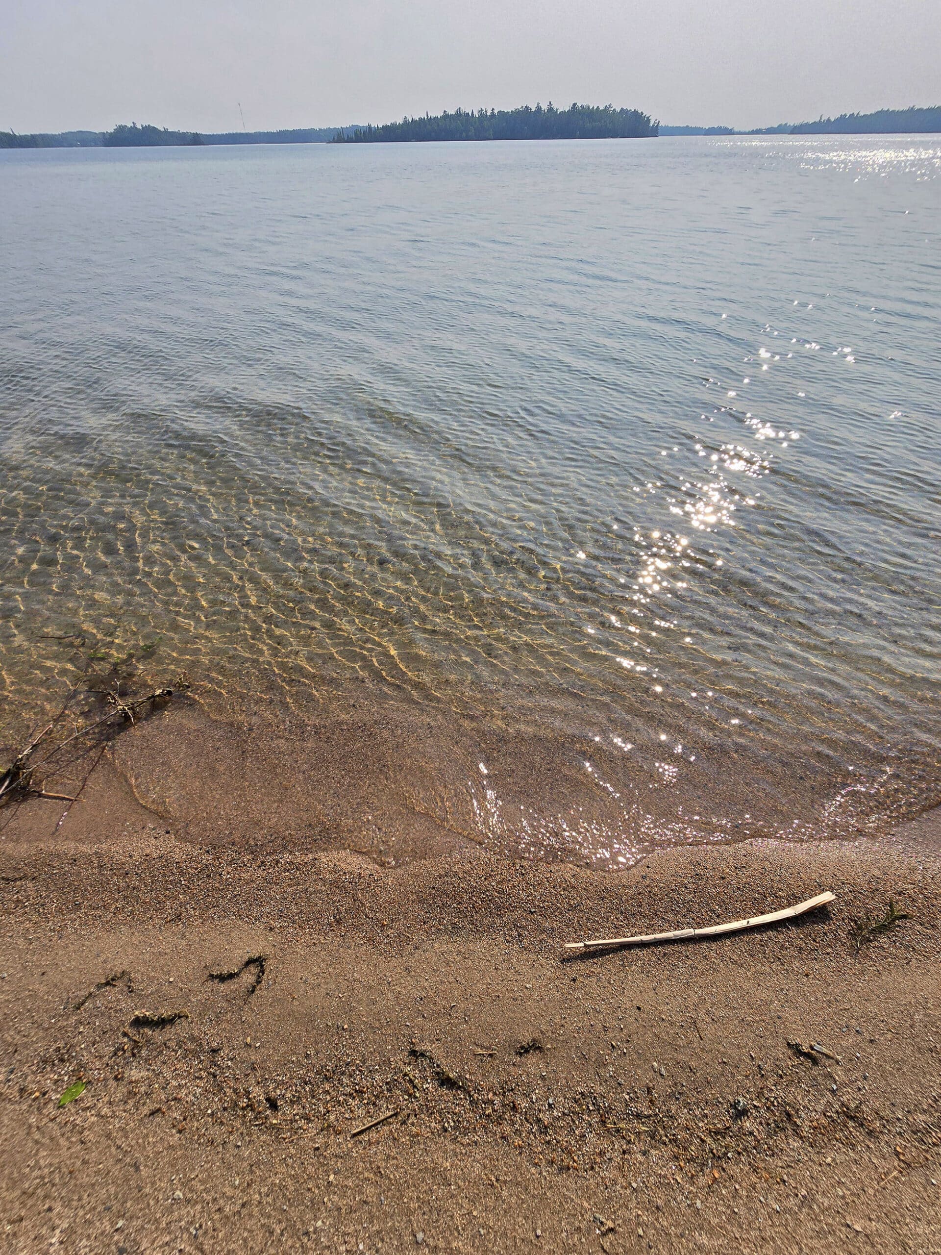 Clear water at a sandy beach.