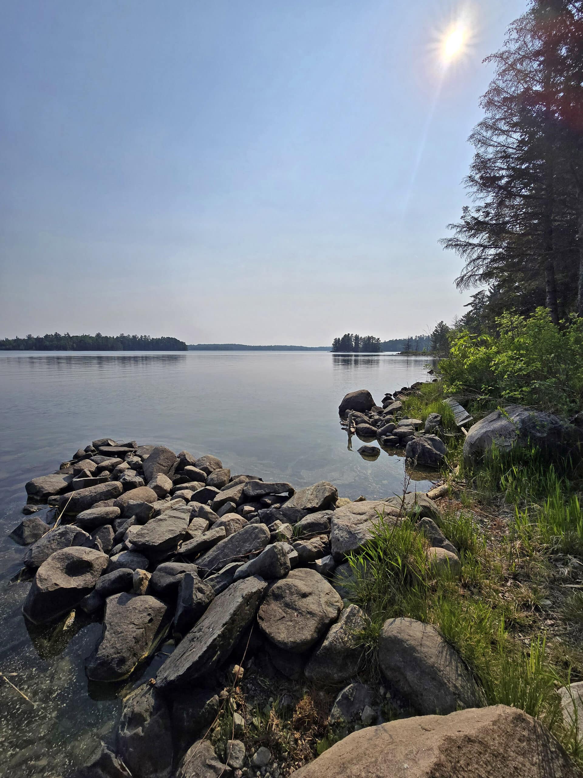 A view of lake of the woods, over some rocks.