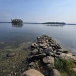 A view of lake of the woods, over some rocks.