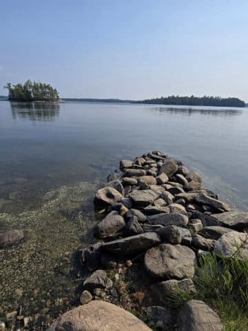 A view of lake of the woods, over some rocks.