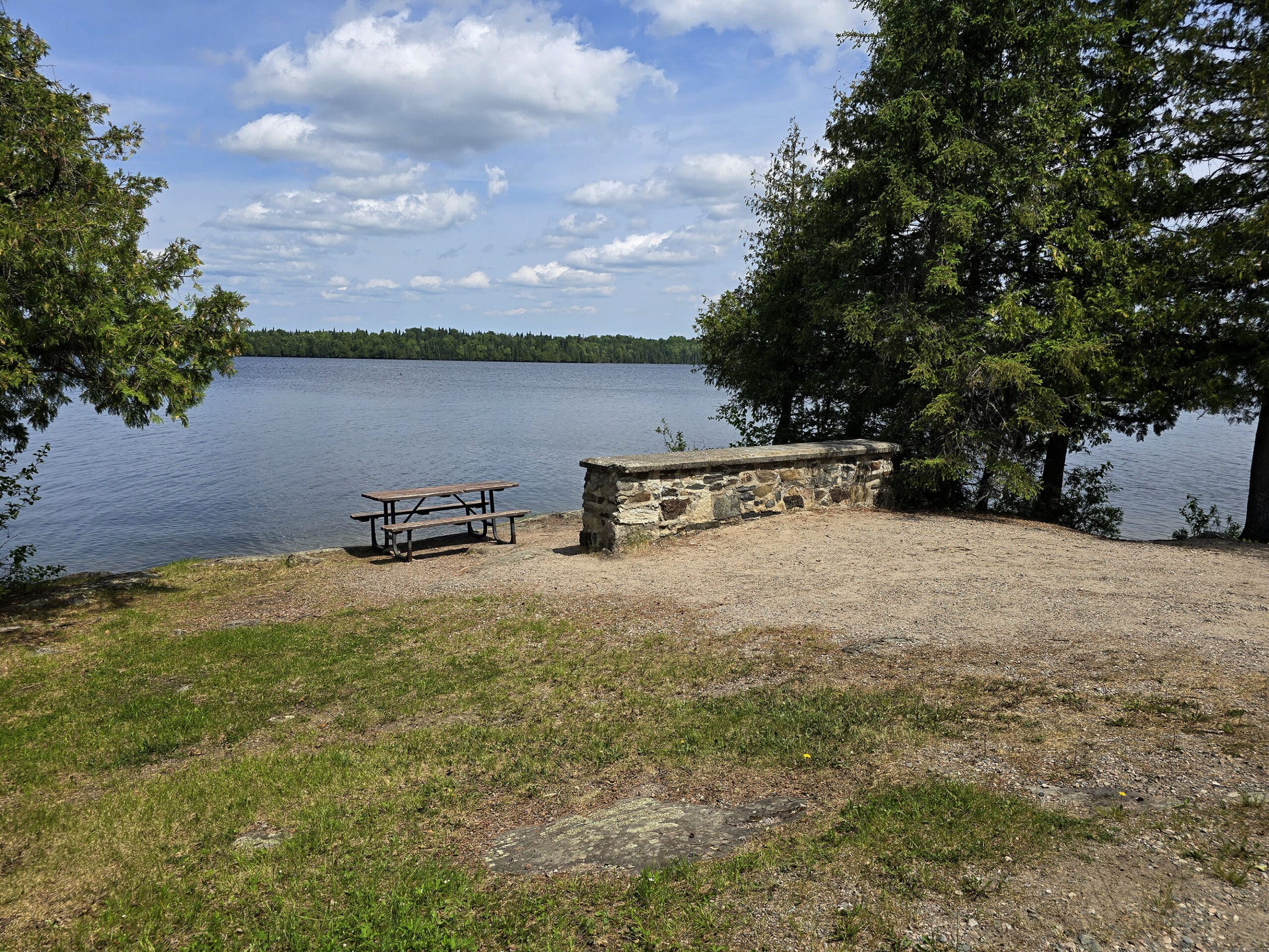 A picnic table overlooking thunder lake.