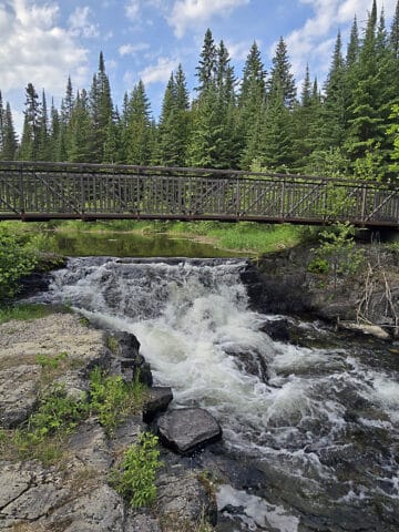 A footbridge over a small waterfall.