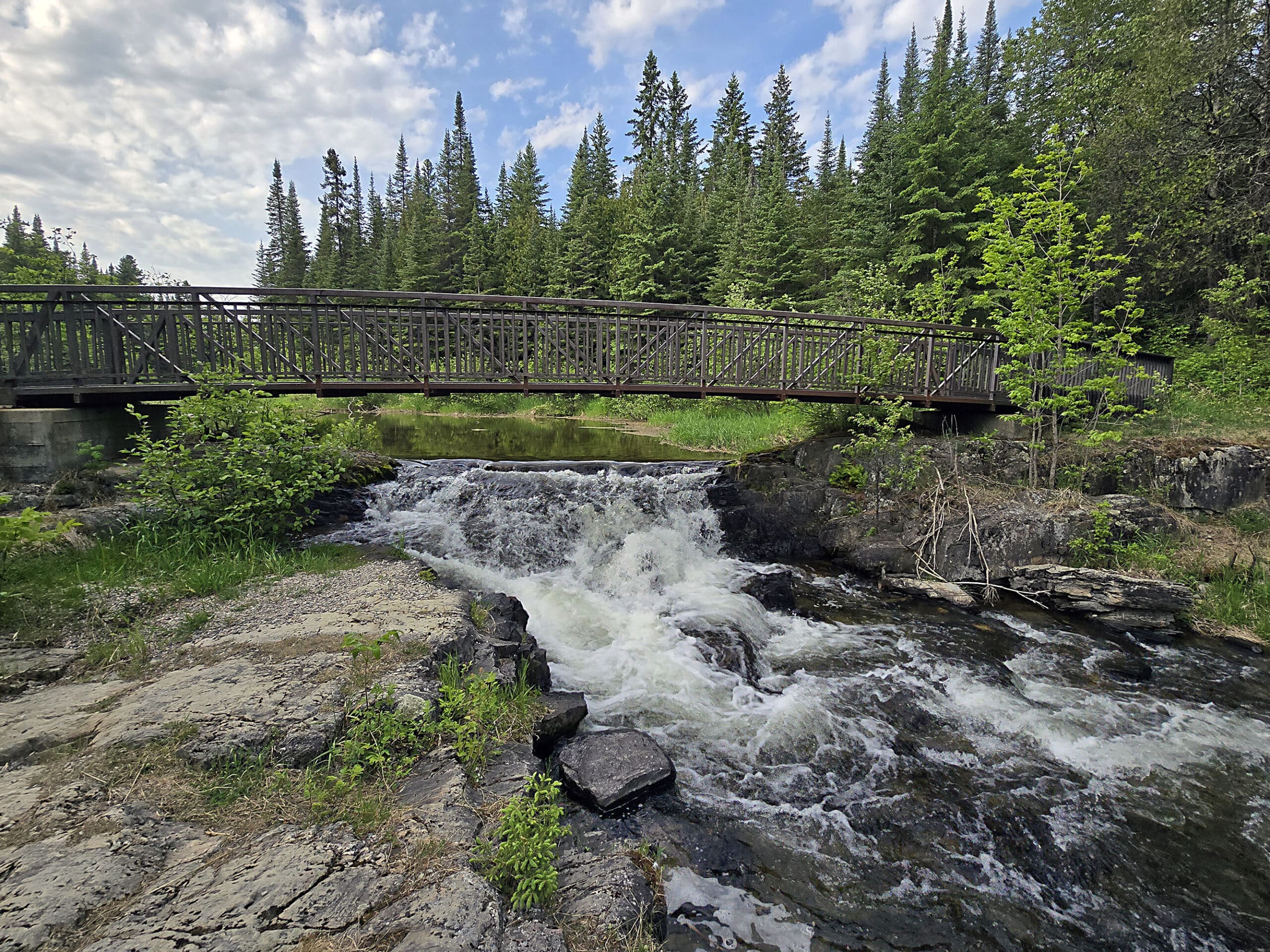 A footbridge over a small waterfall.