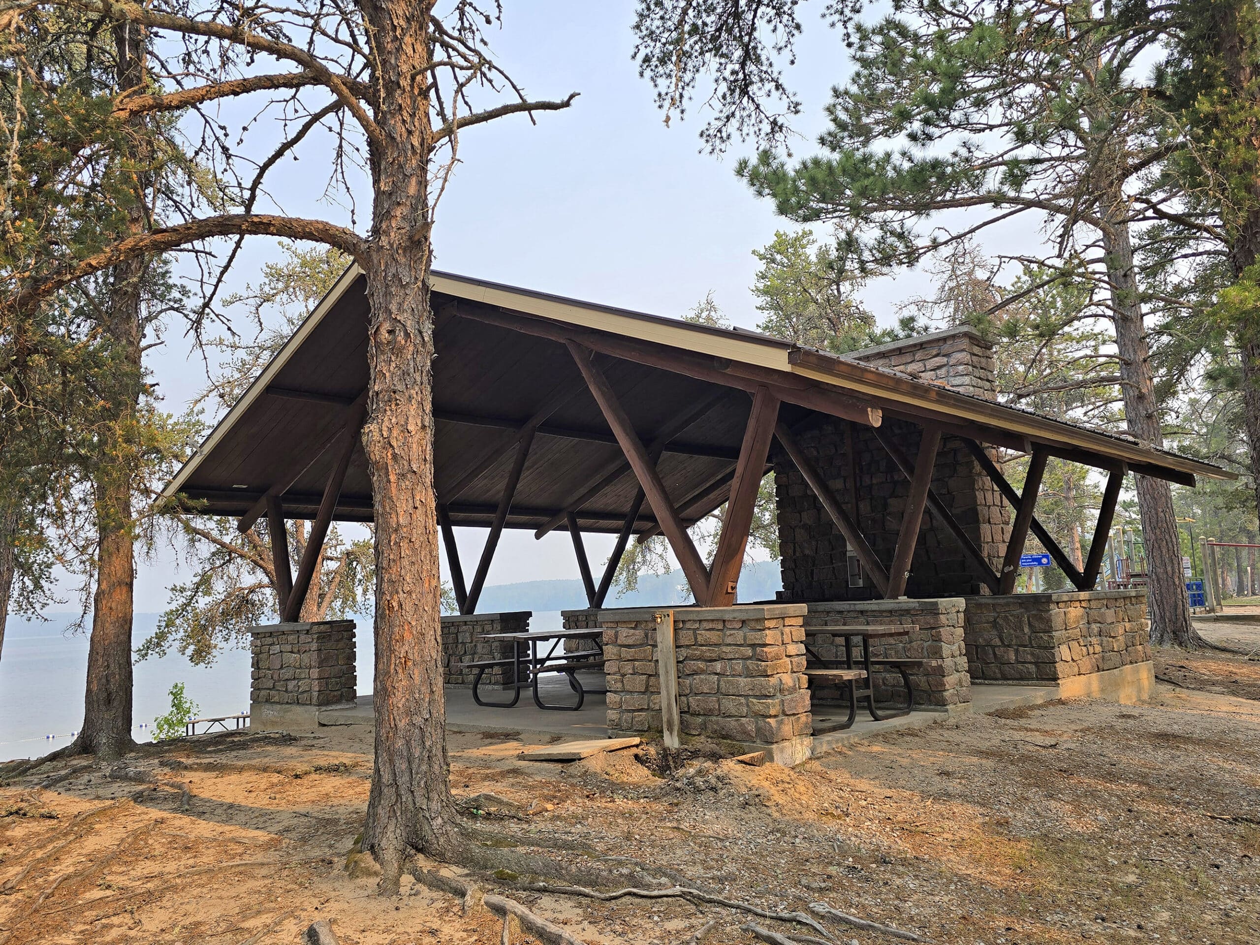 A small, open picnic shelter on the beach at Blue Lake Provincial Park.