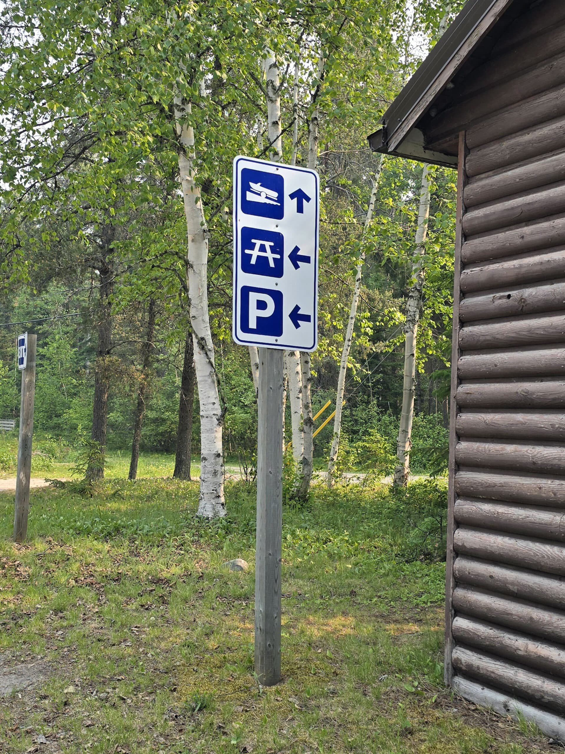 Directional signage pointing to the boat launch, picnic area, and parking.