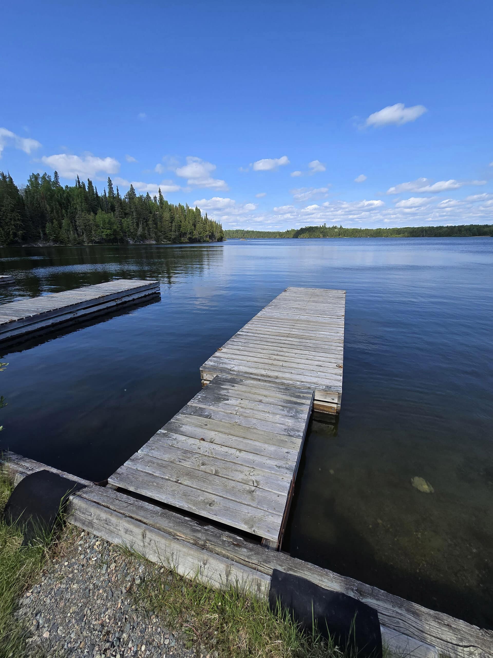 A wooden boat dock on little vermillion lake.