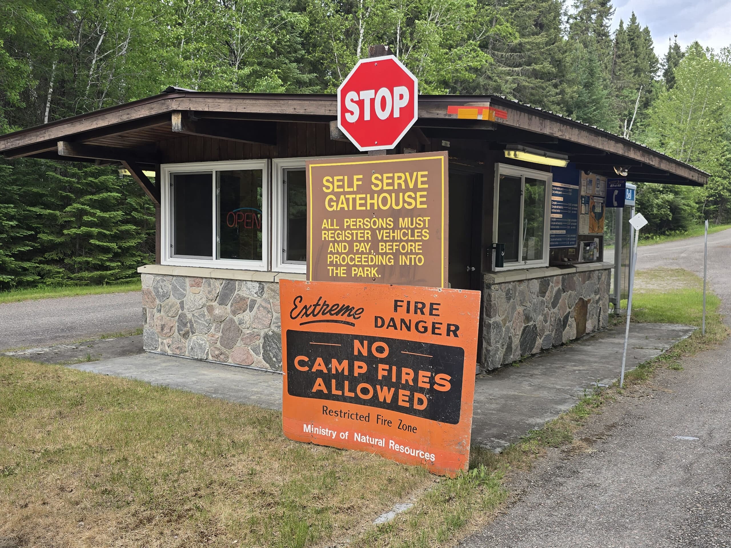 A small gatehouse with signage saying that it is self serve.