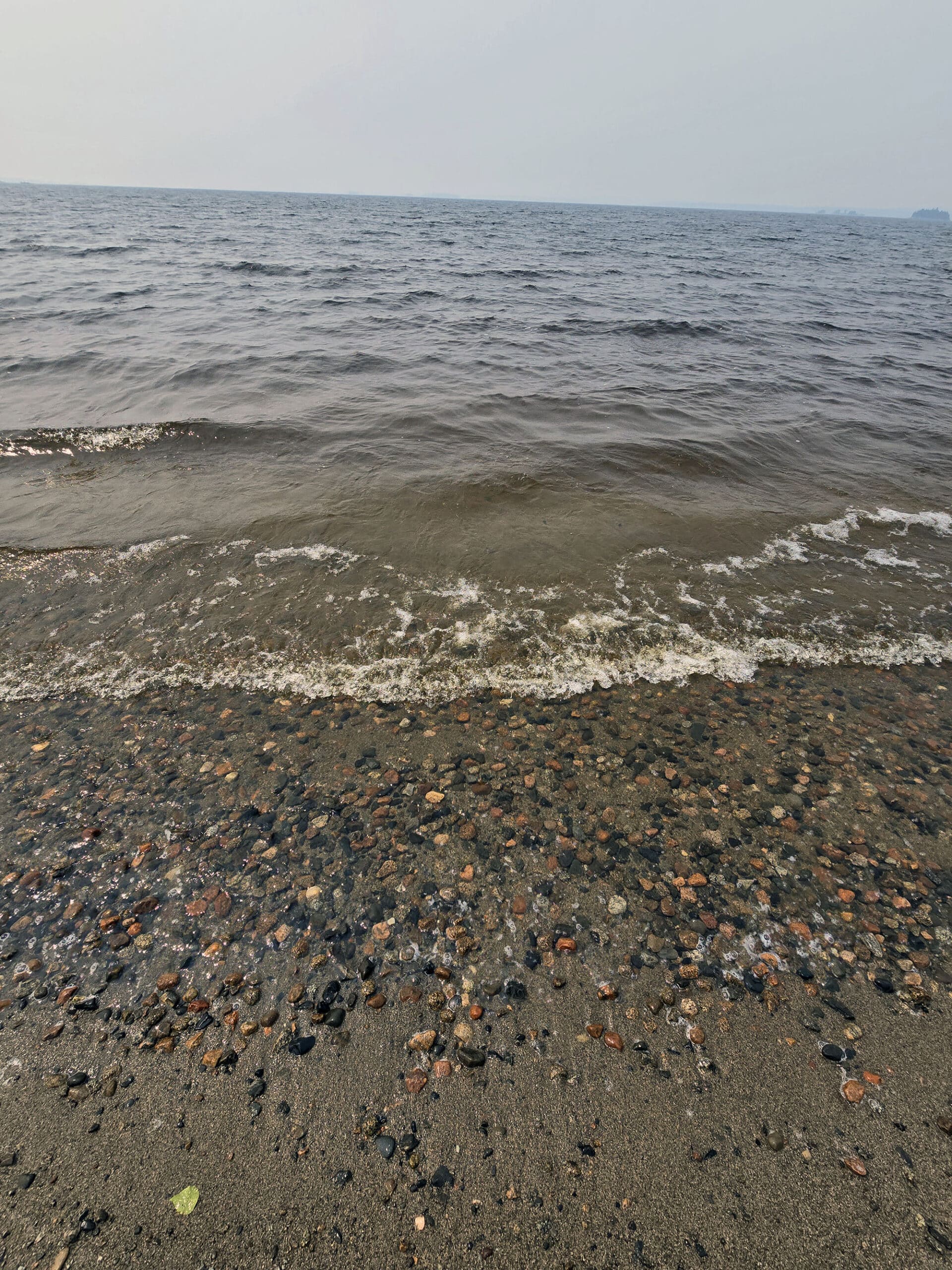 A close up view of the water line at Pakwash Provincial Park beach.