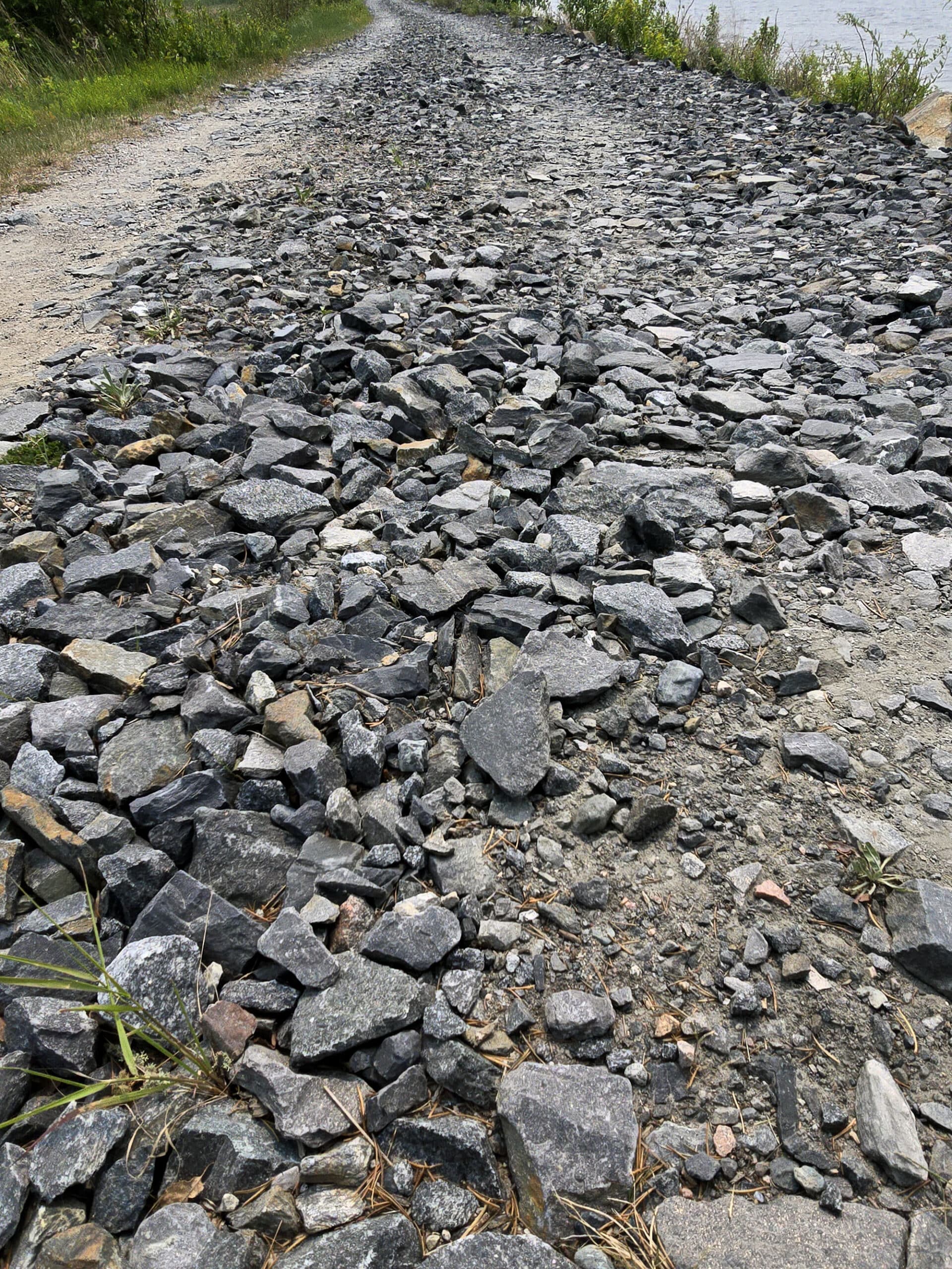 A road covered in large chunks of rock.