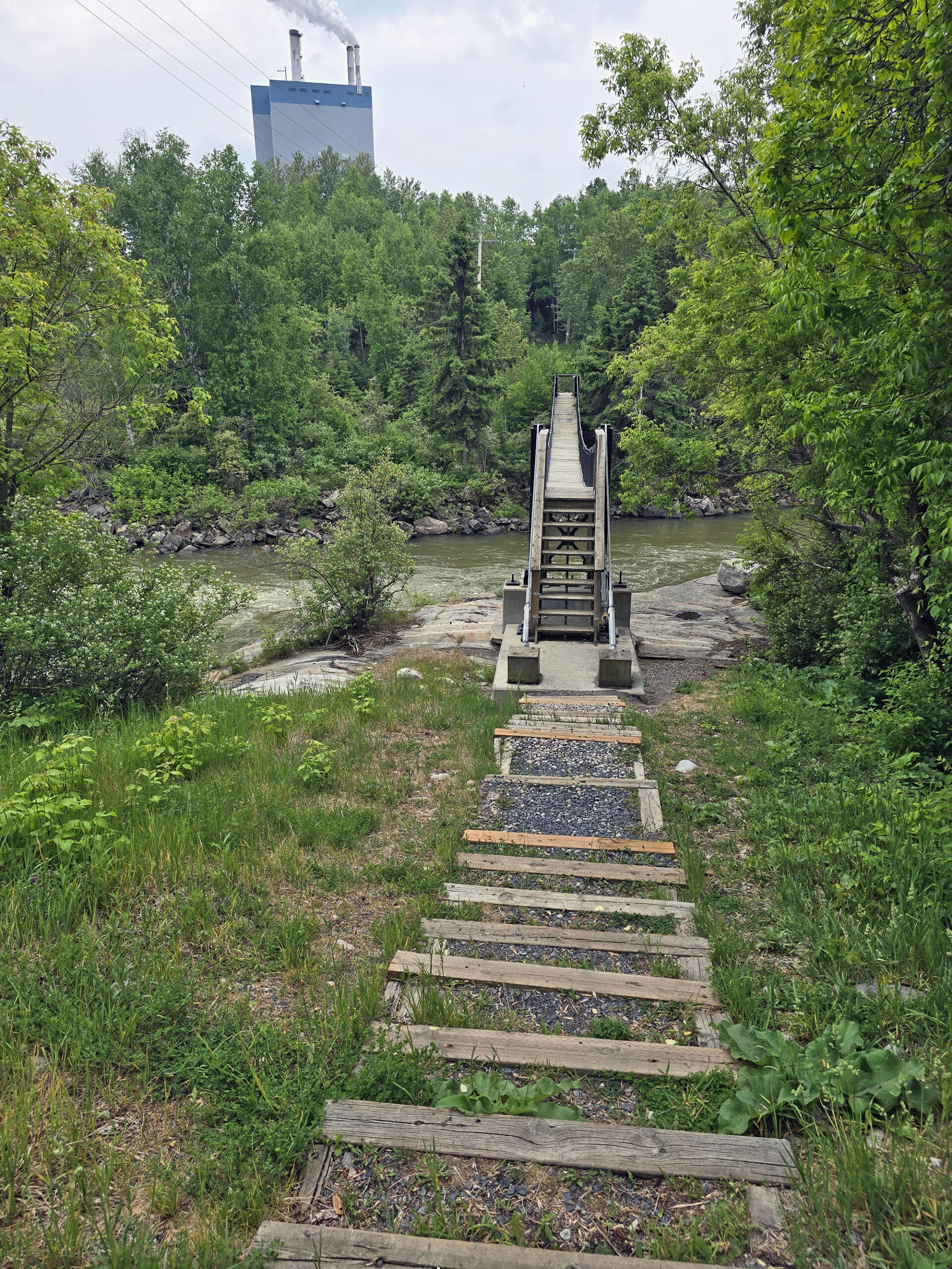 Looking down a set of stairs at the roy wilson bridge in dryden ontario.