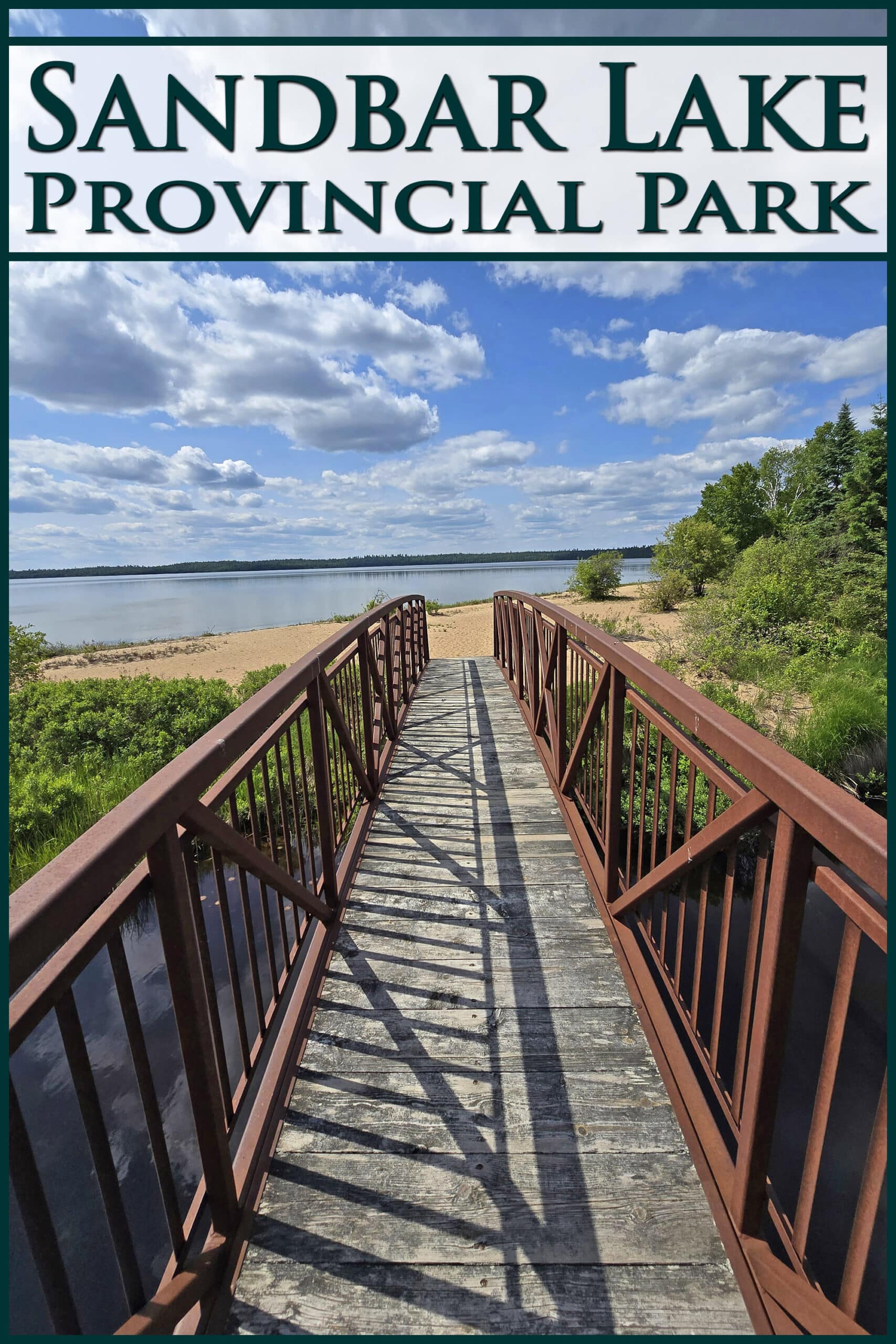 A foot bridge extending towards a beach. Overlaid text says Sandbar Lake Provincial Park.