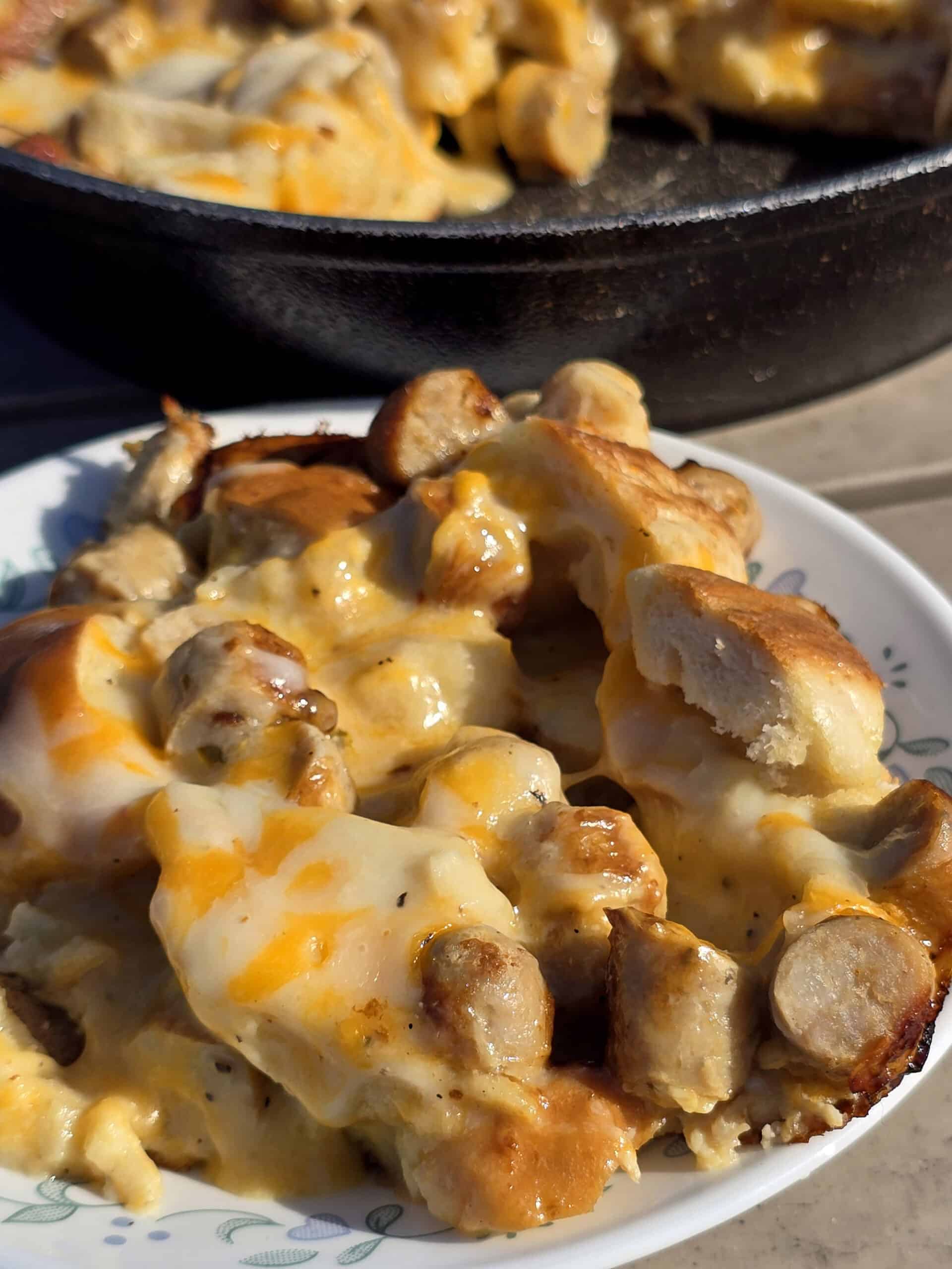 A pan and a plate of bagel breakfast strata with sausage and cheese.