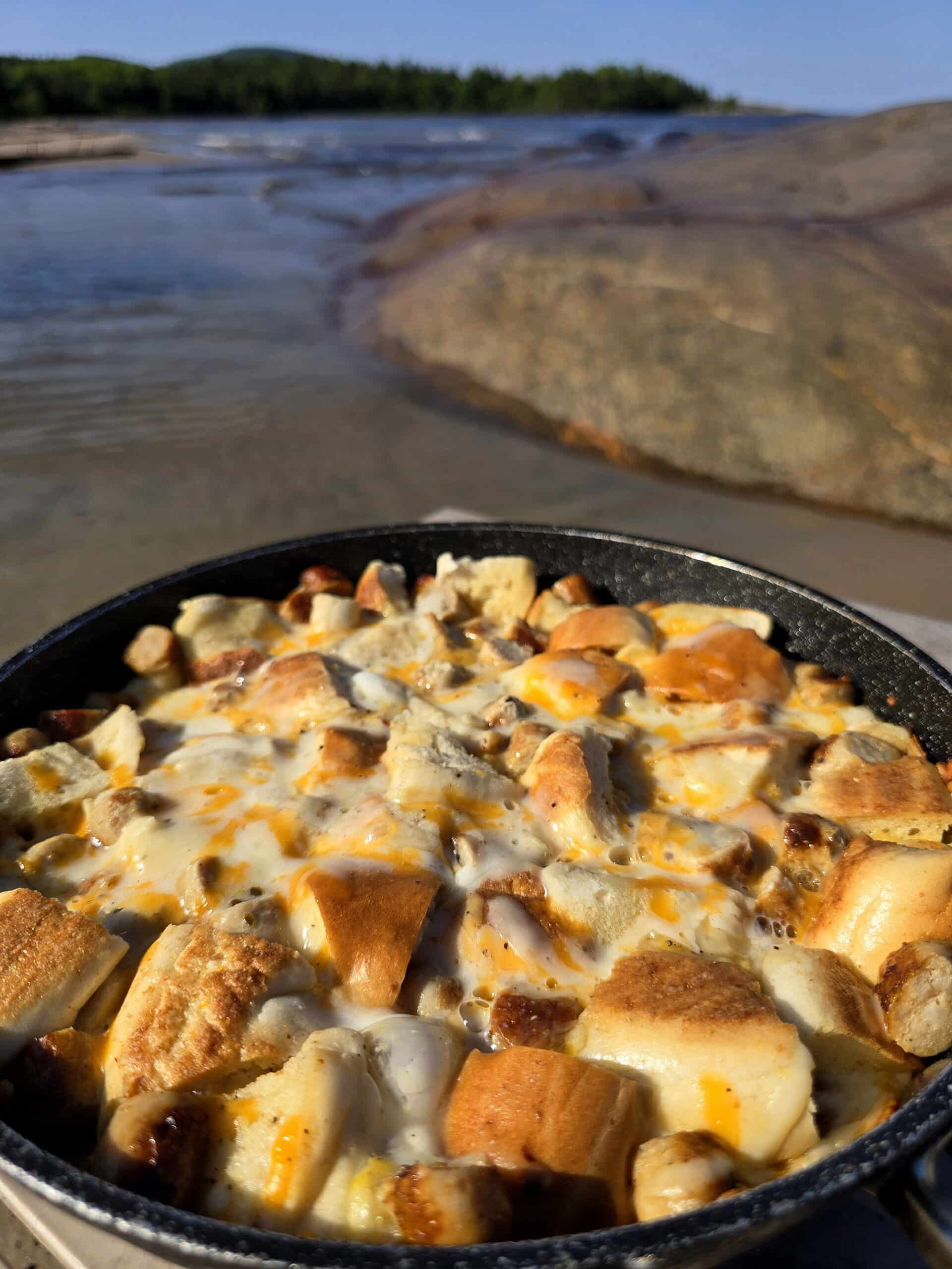 A pan of bagel breakfast strata with sausage and cheese.