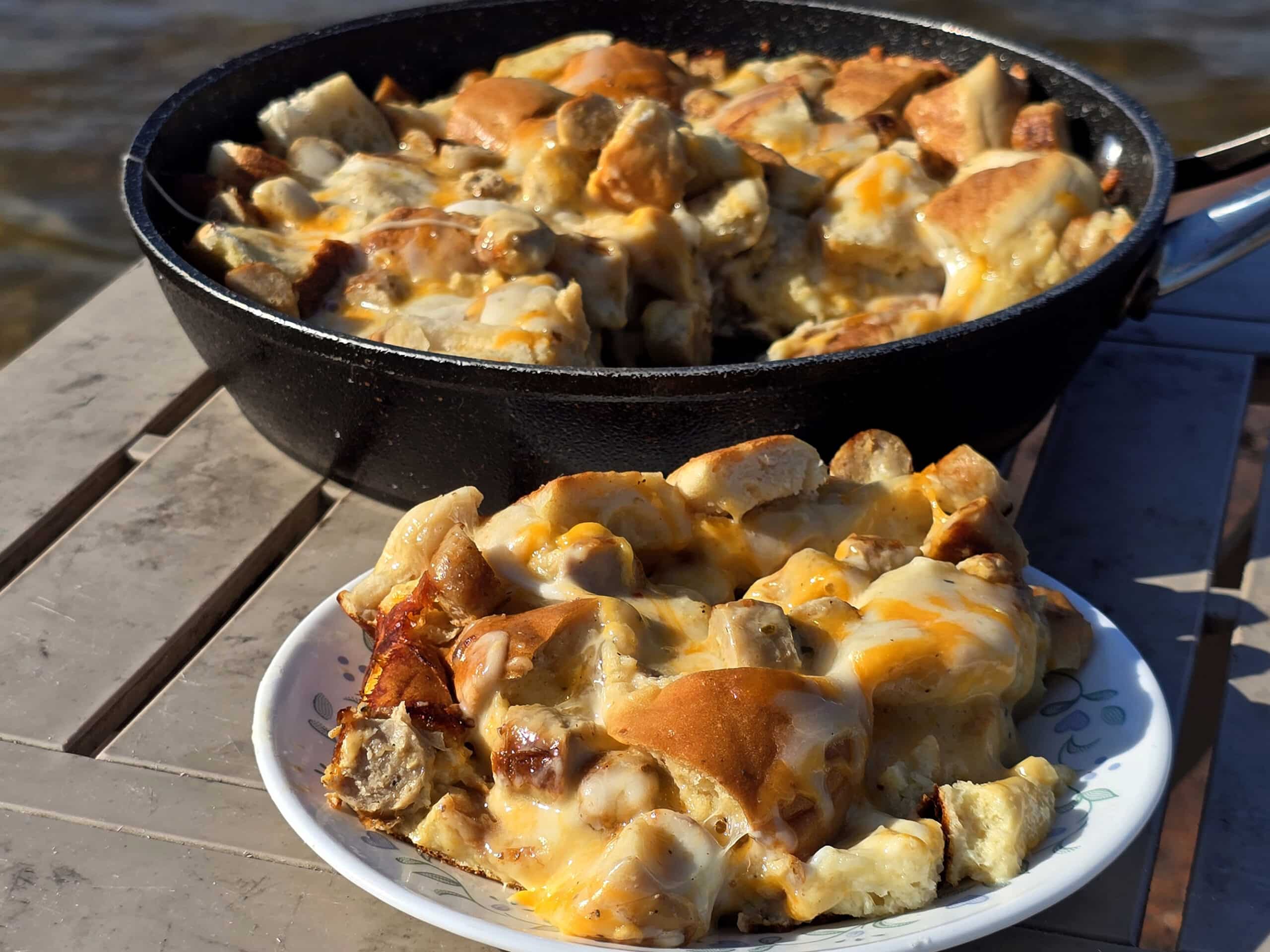 A pan and a plate of bagel breakfast strata with sausage and cheese.